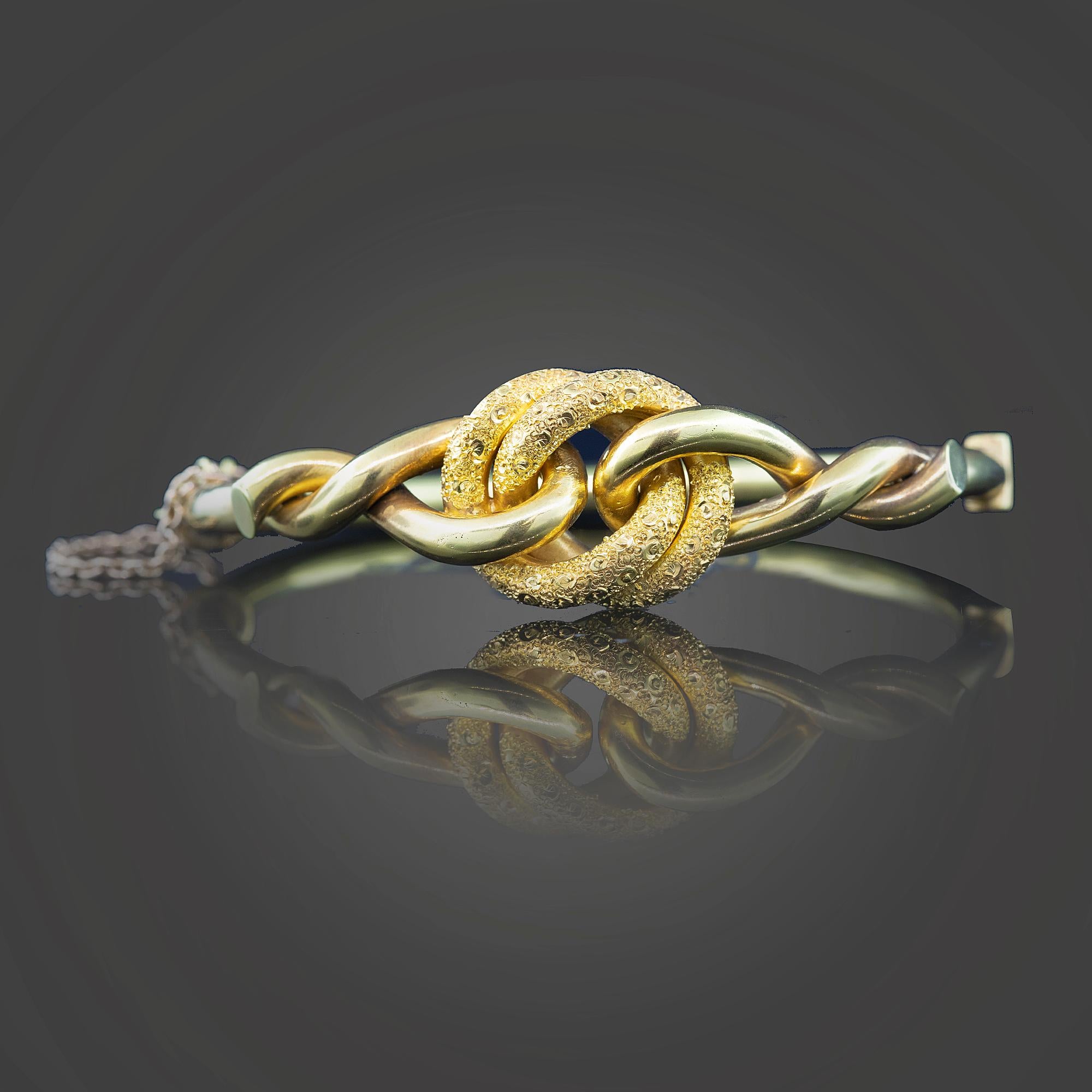 Victorian yellow gold “Lovers Knot” hollow hinged bangle. The knot comprises of a polished and an embossed finish Secured with a box style clasp and fitted with a safety chain.

Metal: 9k yellow gold
Weight: 11.00 grams
Measurements: Inner diameter
