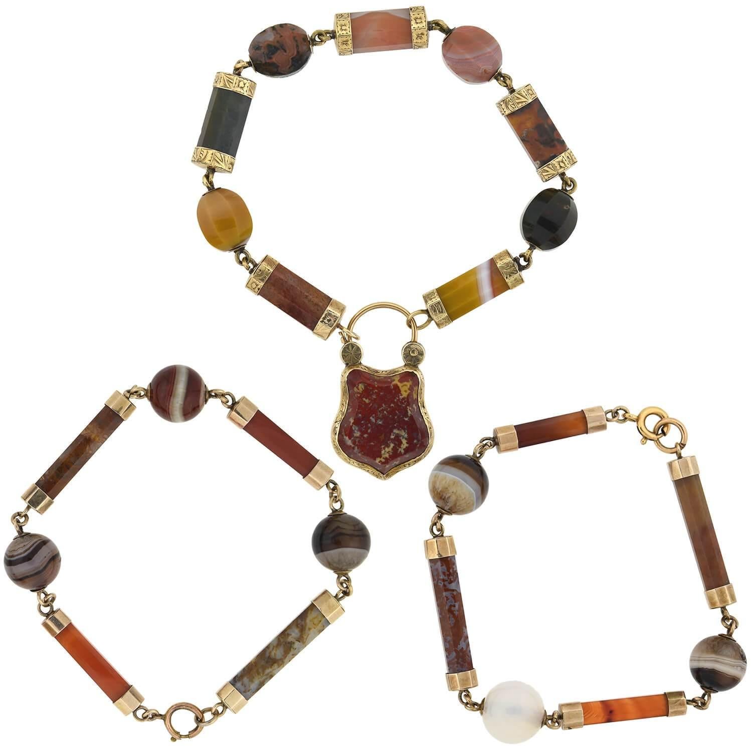 A very unique compilation piece from the Victorian (1880s) era! Displaying a variety of muted rainbow shades against beautiful 9kt yellow gold, this fabulous piece can be worn as either a necklace or a complementary trio of bracelets! Multicolored