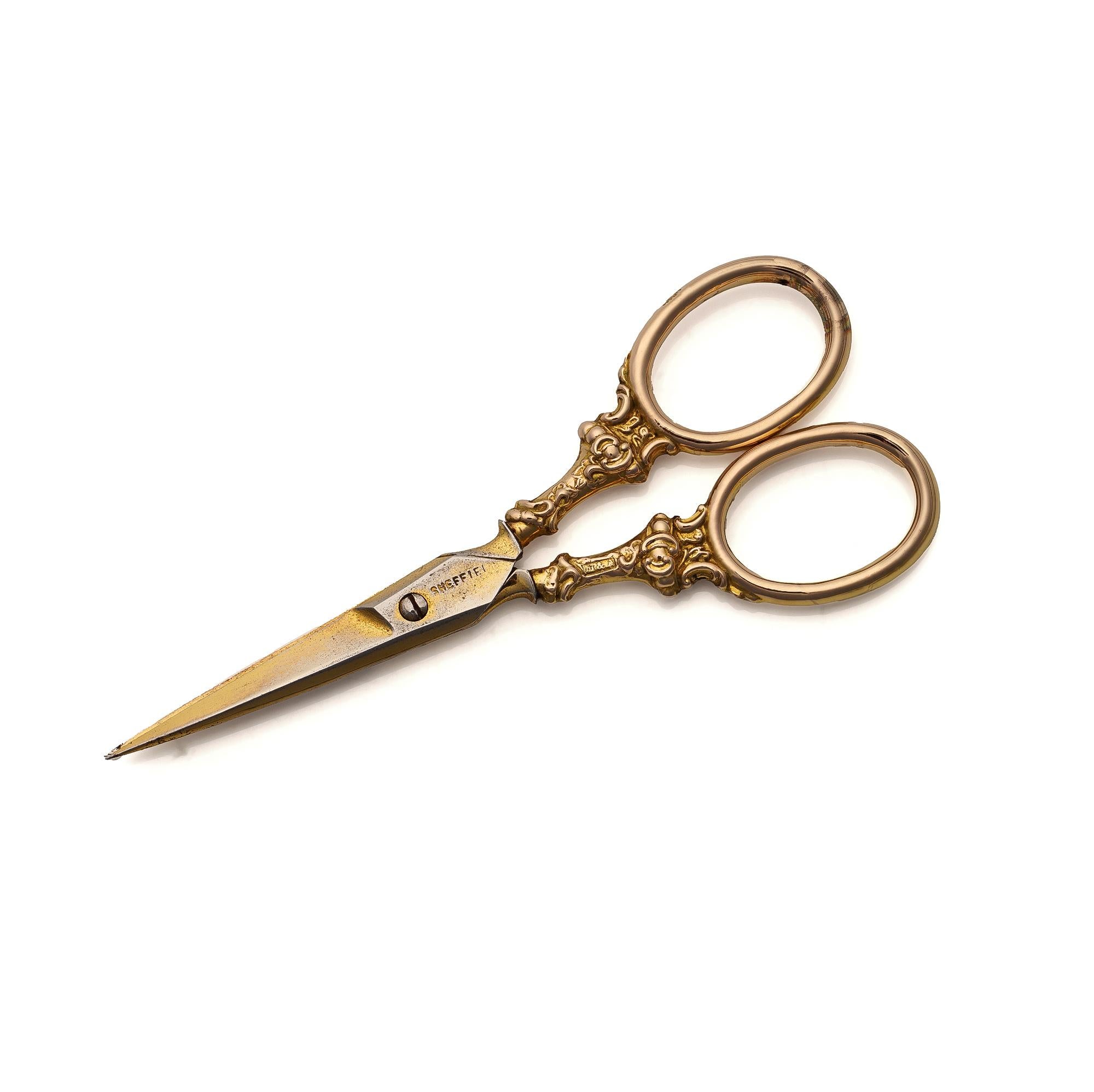 9kt gold scissors crafted by M&A, Birmingham, 1898. These scissors showcase ornate detailing with hallmarks indicating their craftsmanship and origin. The handles are crafted in 9kt gold, while the blades are made of stainless steel, combining
