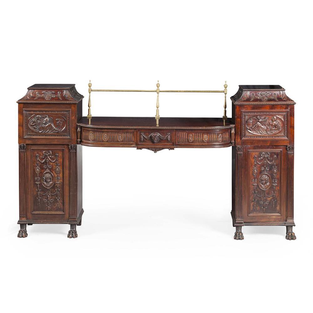 Exhibition quality Victorian copy of an Adam pedestal sideboard in the classic shape, circa 1880. The centre section has a brass gallery finished with urns, and a crossbanded edge. The front is convex with a carved beading on the fore edge. There
