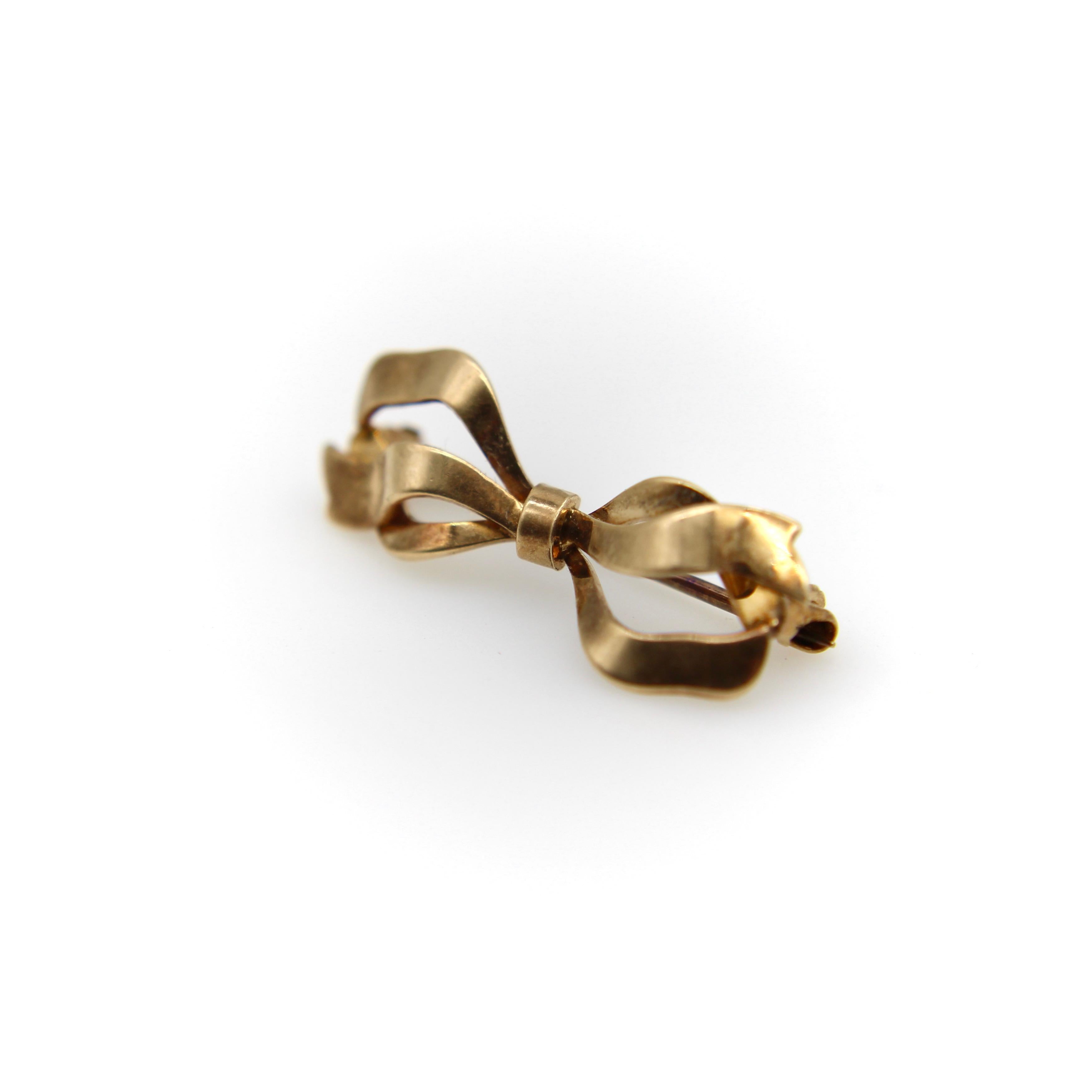 Circa the Victorian era, this 14k gold brooch is a tiny adorable little bow. The bow is lyrical, like a flowing ribbon you’d wear in your hair, and has a wonderful patina that adds to its charm. For its tiny size, the brooch has lots of details,