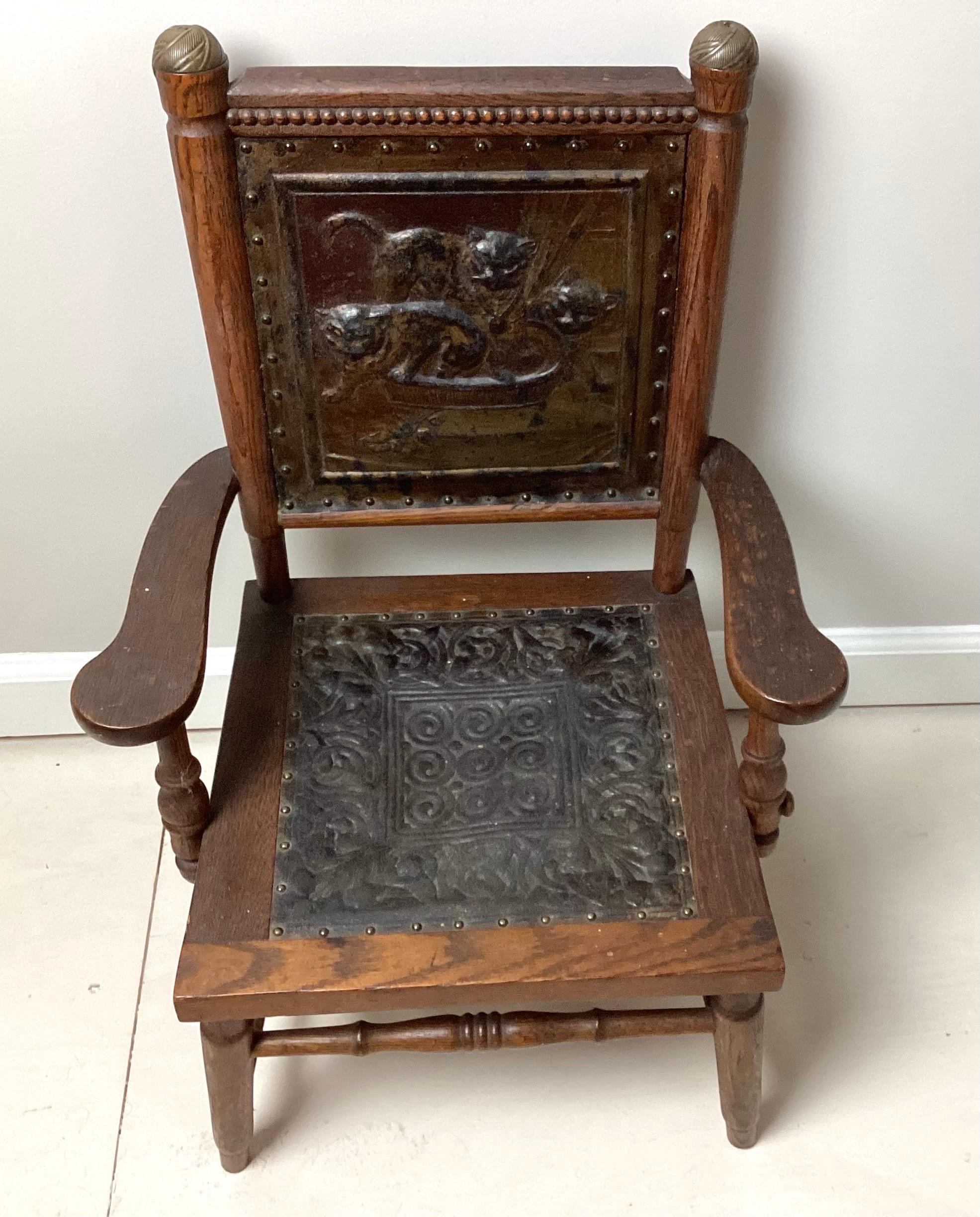 Victorian Aesthetic Movement Childs Chair with Pressed Leather Cats on Seat Back. 17” wide by 14” deep by 24  1/2” tall seat hight 10”. Pressed leather seat has old repair. This chair is in old original condition.