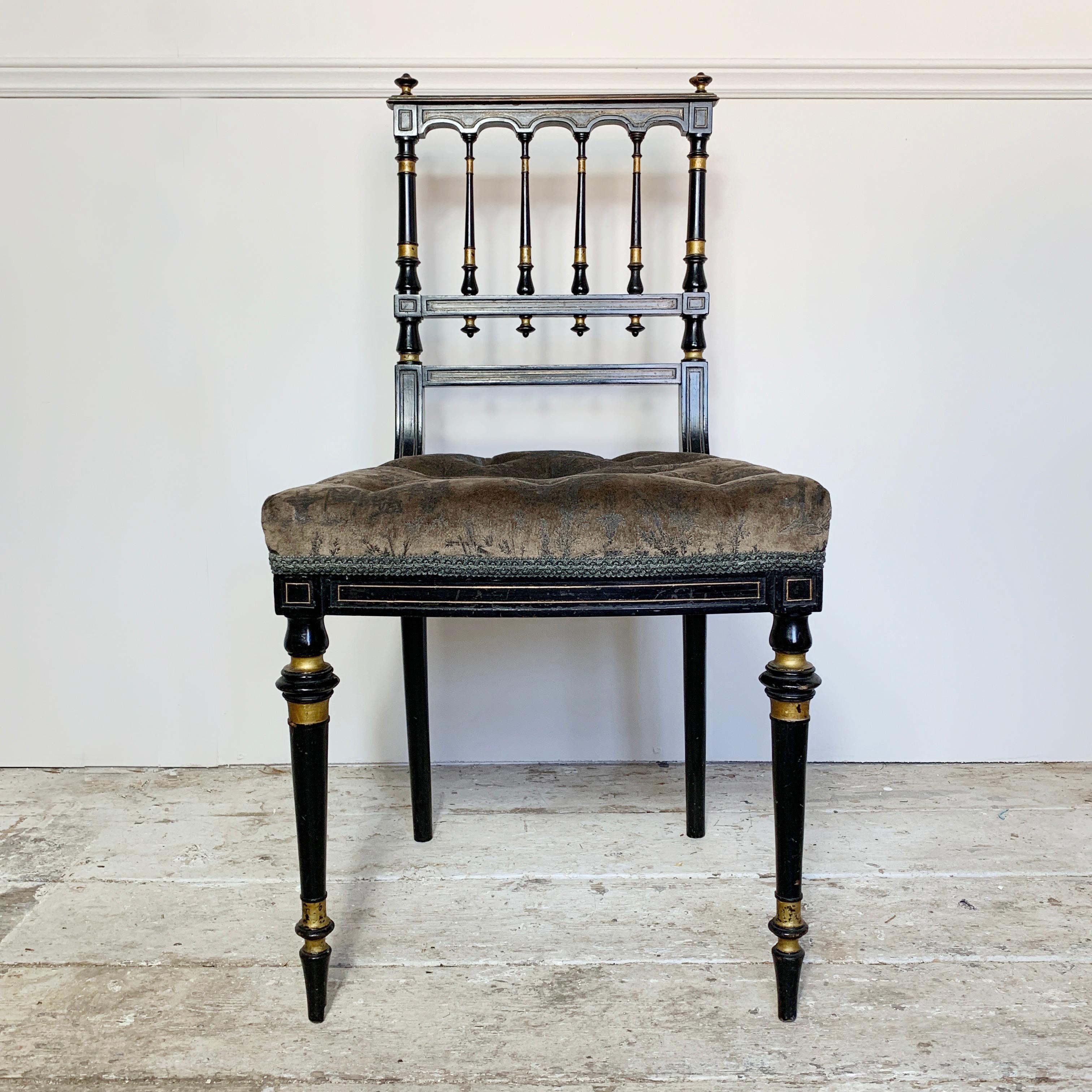 Antique Victorian aesthetic movement side chair
Ebonized with gilt detailing
Spindle back with finial decoration,
circa 1860-1875
The seat is deep buttoned in an oriental scene fabric, previously re-upholstered
Excellent structural condition