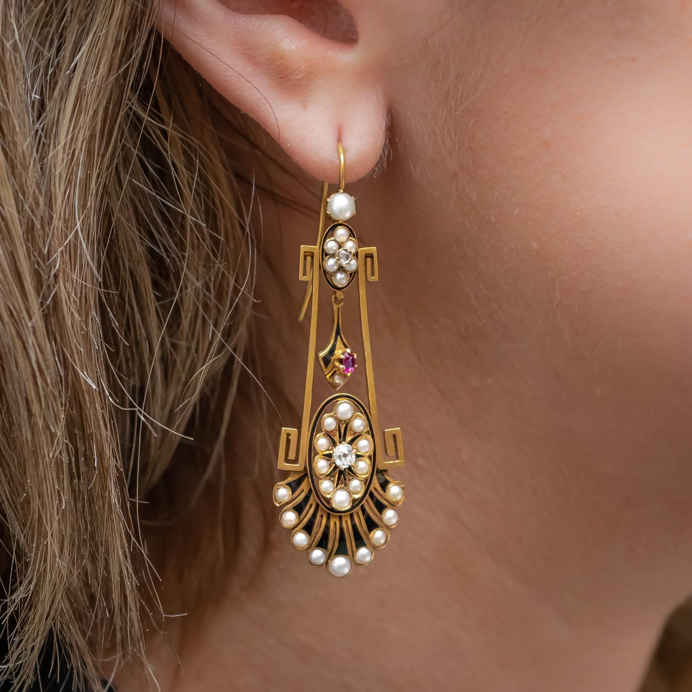 A pair of Victorian, Aesthetic Movement, drop earrings, set with natural half seed pearls, old and rose-cut diamonds and rubies, with black enamel, mounted in gold, on hooks, circa 1875.