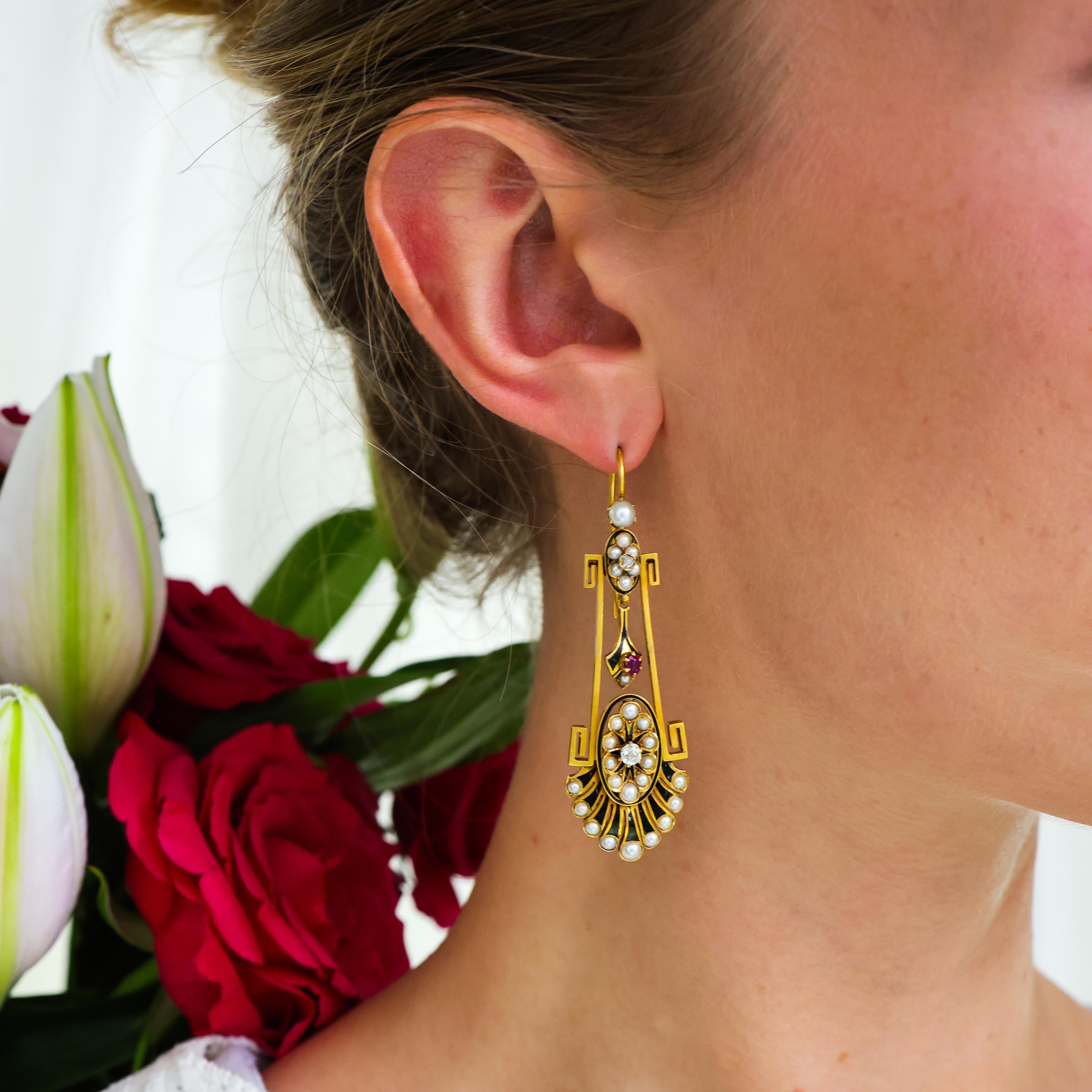 A pair of Victorian, Aesthetic Movement, drop earrings, set with natural half seed pearls, old and rose-cut diamonds and rubies, with black enamel, mounted in gold, on hooks, circa 1875. With French owl, modern, import marks.

