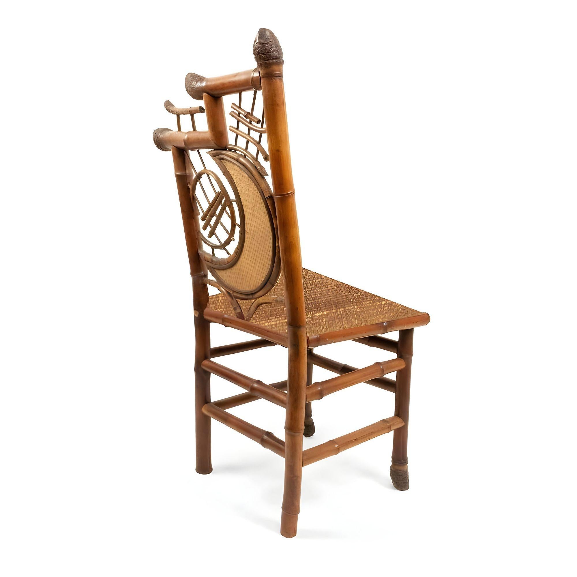 Original Aesthetic Movement bamboo side chair featuring a unique half-moon design back. These chairs blend tribal almost occult vibes with high-style Victorian styling. Crafted with an intricate bamboo frame and rice mat covered seat the chair has