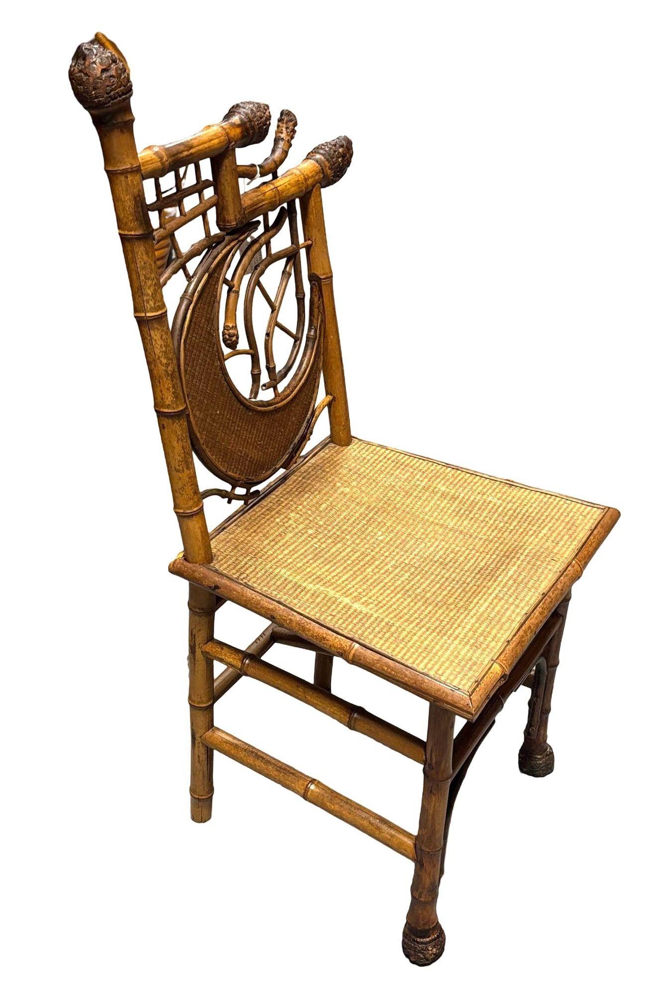 The Original Aesthetic Movement bamboo side chair features a unique half-moon design back. These chairs blend tribal, almost occult vibes with high-style Victorian styling. Crafted with an intricate bamboo frame and rice mat-covered seat, the chair
