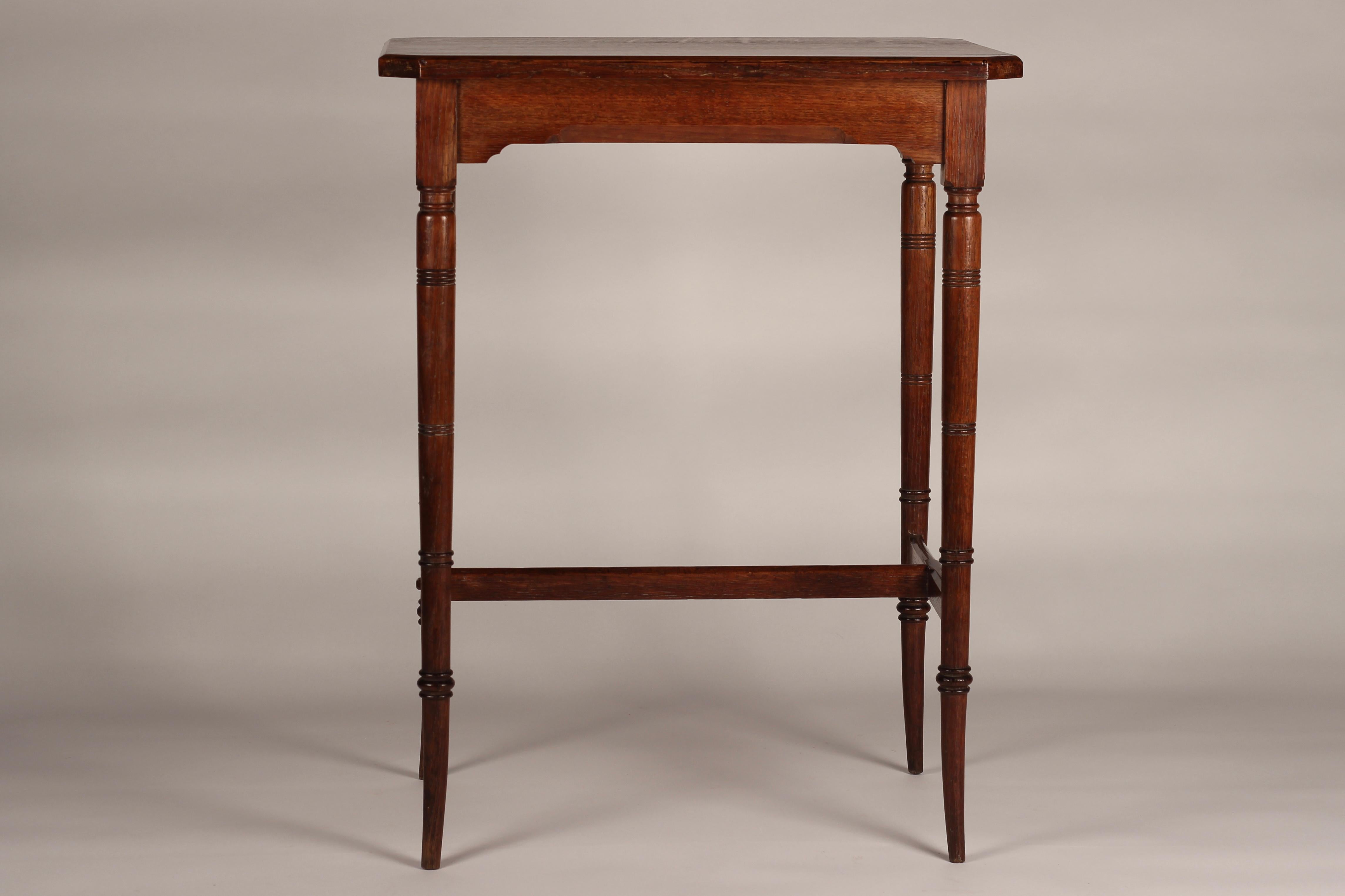 A Victorian Aesthetic movement oak side table or occasional table, beautifully detailed, proportioned and crafted in the style of Edward William Godwin, inspired and influenced by Japan and China with reference to faux Bamboo on the saber style