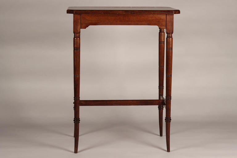 A Victorian Aesthetic movement oak side table or occasional table, beautifully detailed, proportioned and crafted in the style of Edward William Godwin, inspired and influenced by Japan and China with reference to faux Bamboo on the saber style