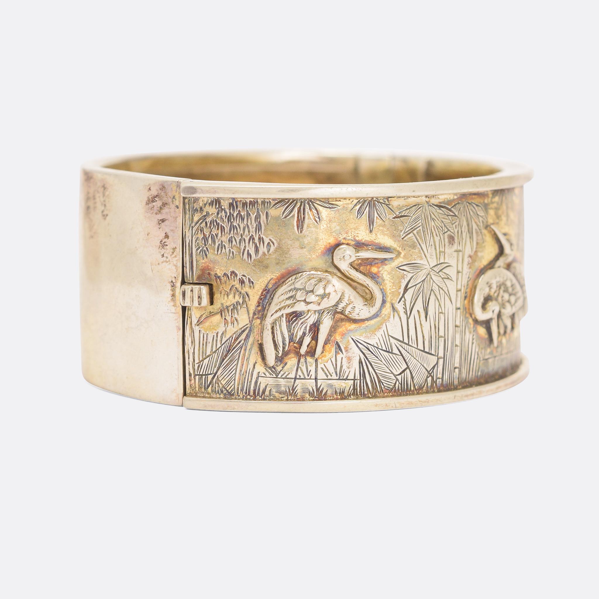 A cool Victorian silver cuff bangle worked in the Aesthetic style with storks and a gorgeous hand-chased jungle backdrop. It's crafted in Sterling silver and dates from the 1880s.

The English Aesthetic Movement was directly inspired by the London