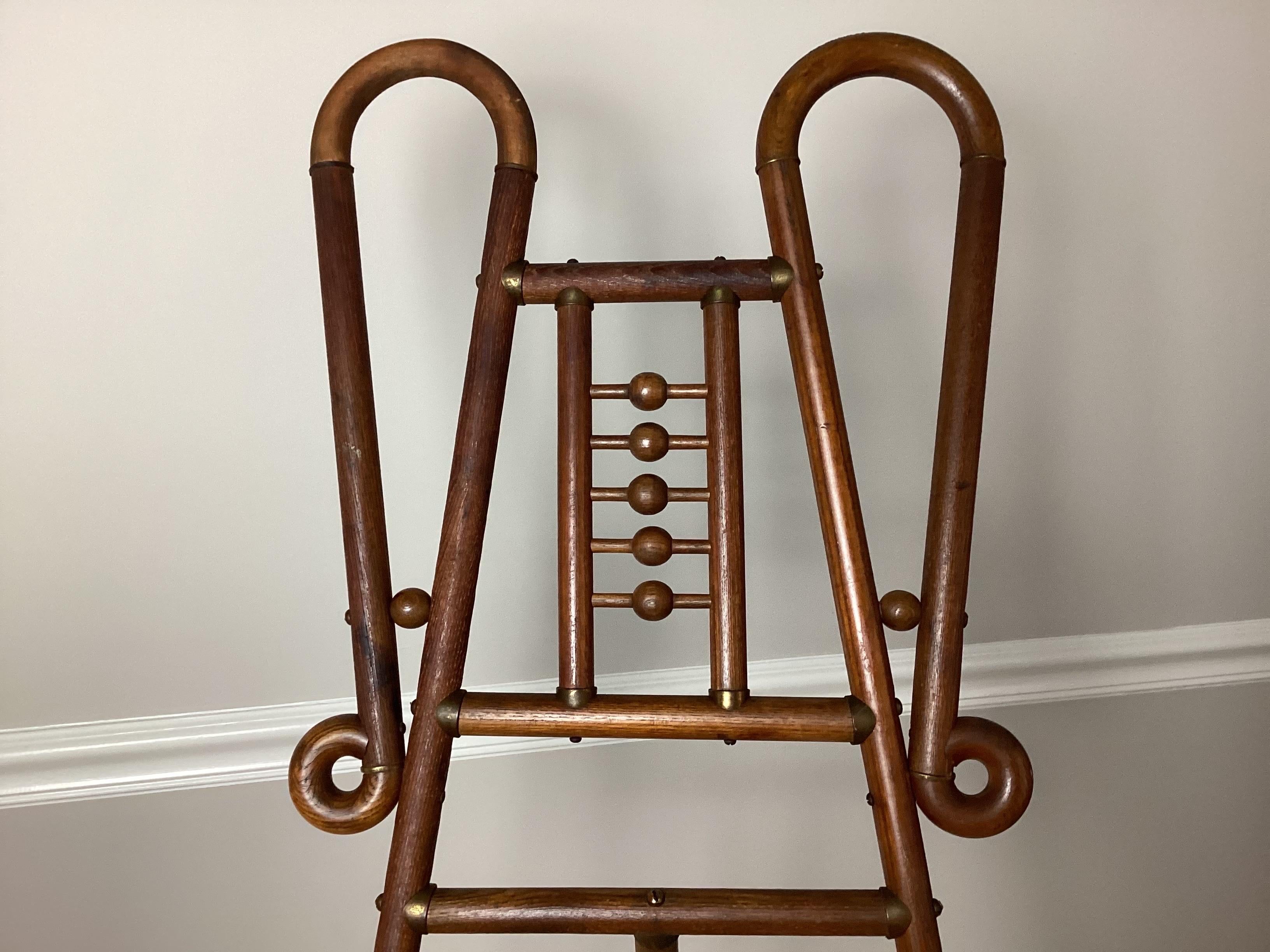 Victorian Aesthetic Movement Style Bentwood Art Easel. Brass mounts. 62” tall by 20”. Closed 4” deep fully open 31”. Easel back leg has a little warp to it but works just fine.