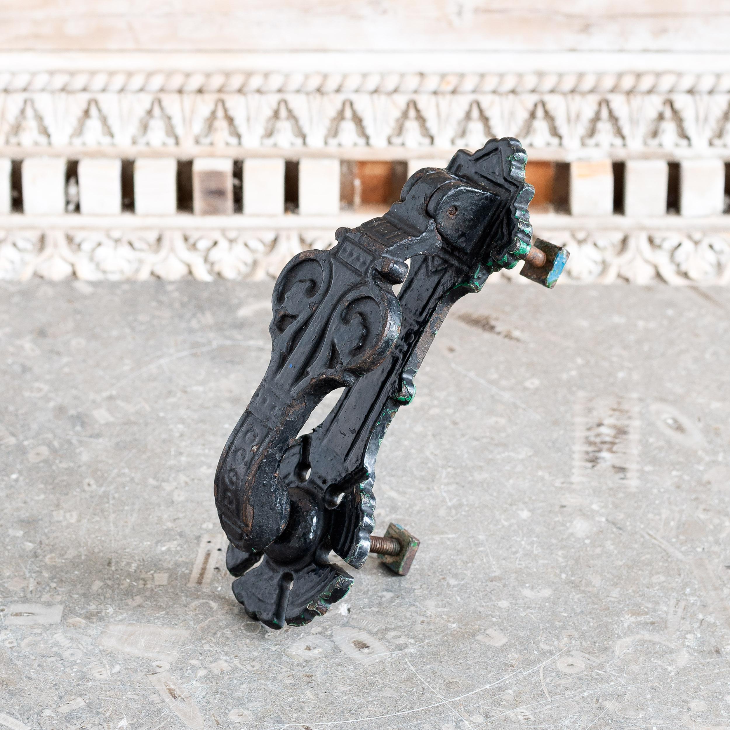 A Victorian aesthetic period cast iron door knocker by Kenrick, in the manner of Christopher Dresser, stamped to the rear ‘A K & Sons 405’, with old black paint finish.