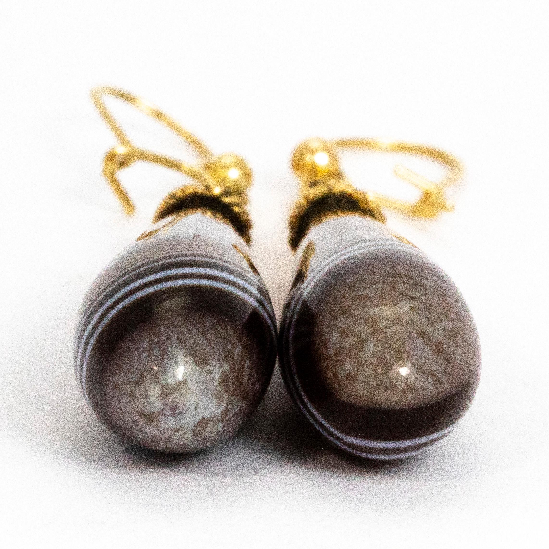 These gorgeous banded agate stones are shaped into tear drops and have a gorgeous gloss on them. The colours running through the stone are all different shades of brown and have bright white bands which cut through the different tones. The earrings