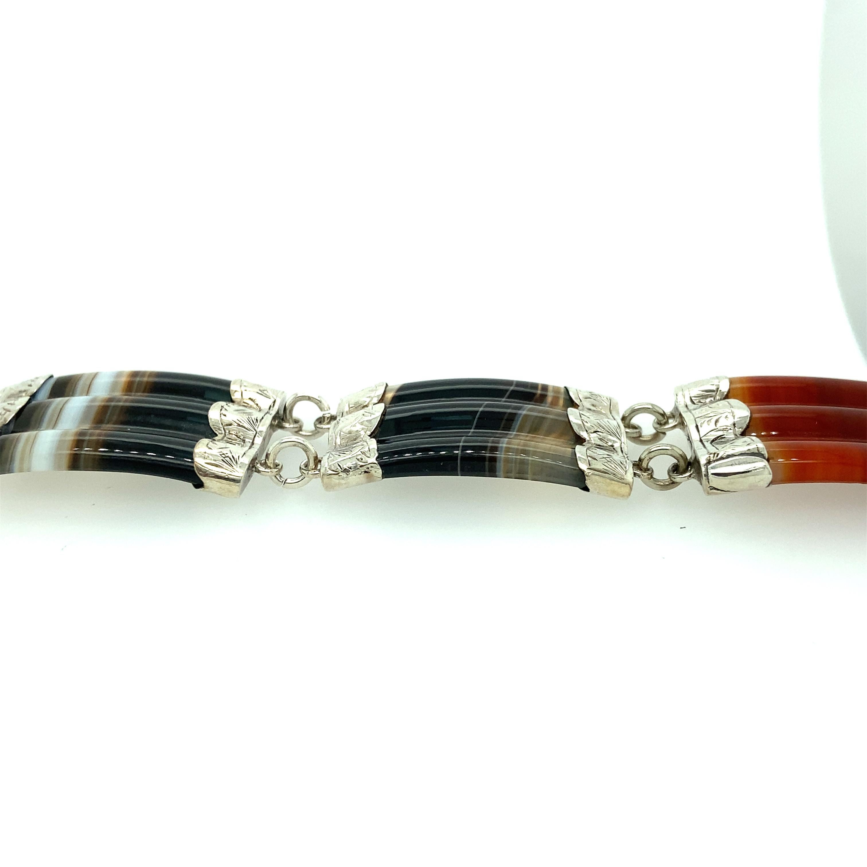 One sterling silver estate Victorian agate belt design bracelet measuring 8 inches long, 1 inch wide with belt style closure and safety clasp. 