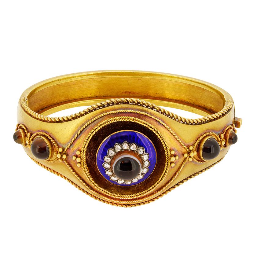 Dating back to 1880s, is this engaging/impressive agate and diamond enamelled bangle. Set to the centre is one cabochon cut agate, surrounded by a row of fifteen rose cut diamonds and blue enamelling. To either side of the bangle are two cabochon