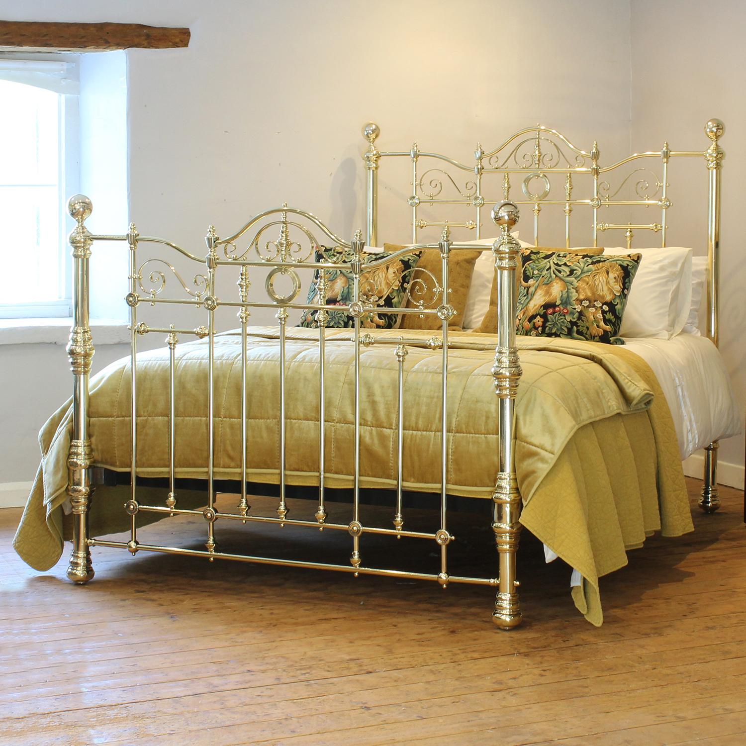 A superb top quality all brass Victorian antique bed with matching decorative gallery in head and foot panels, which feature scrolls, ornate cast fittings, trumpets and rings. This bed has the traditional round brass knobs fitted to the tops of