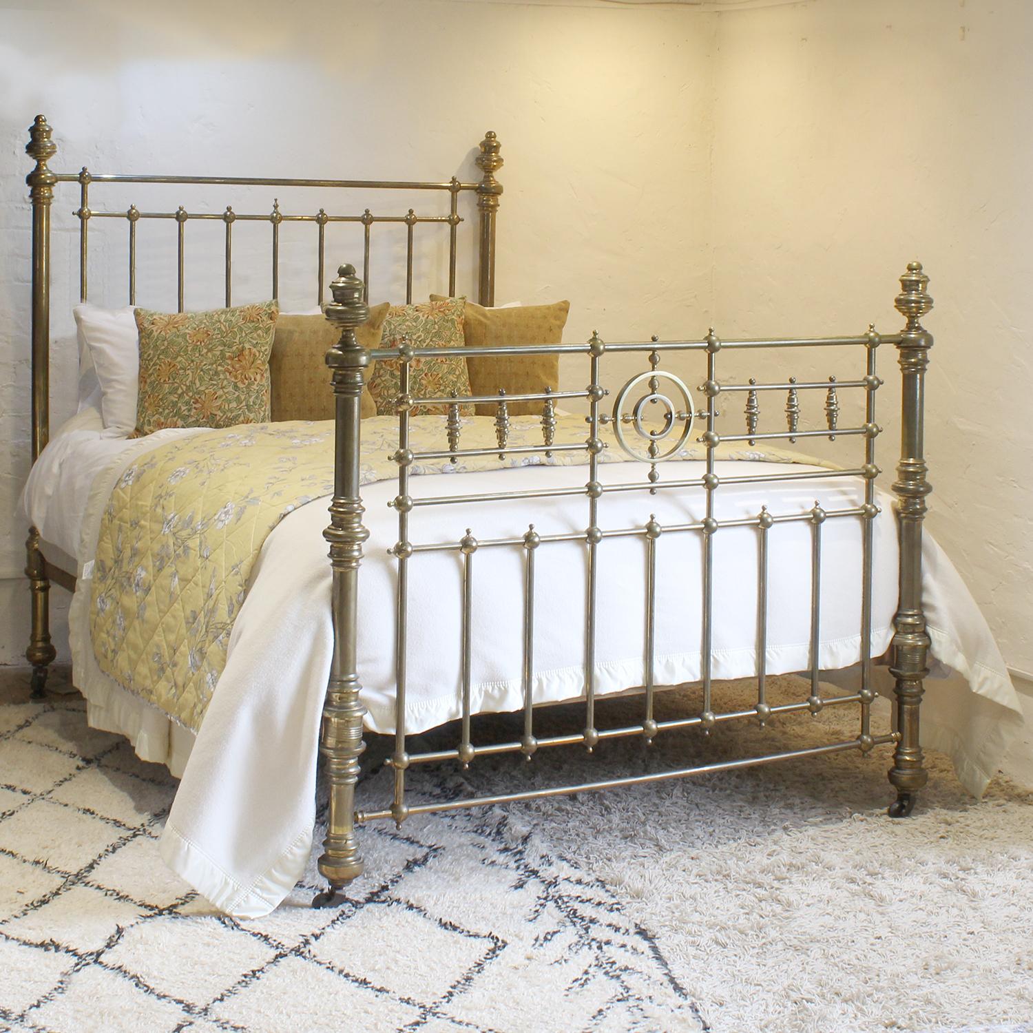 A magnificent all brass Victorian antique bed with decorative foot panel, featuring trumpets and concentric rings, and decorative fittings.
This bed has its original lacquer, which has faded in places. We can repolish the brass if necessary and even
