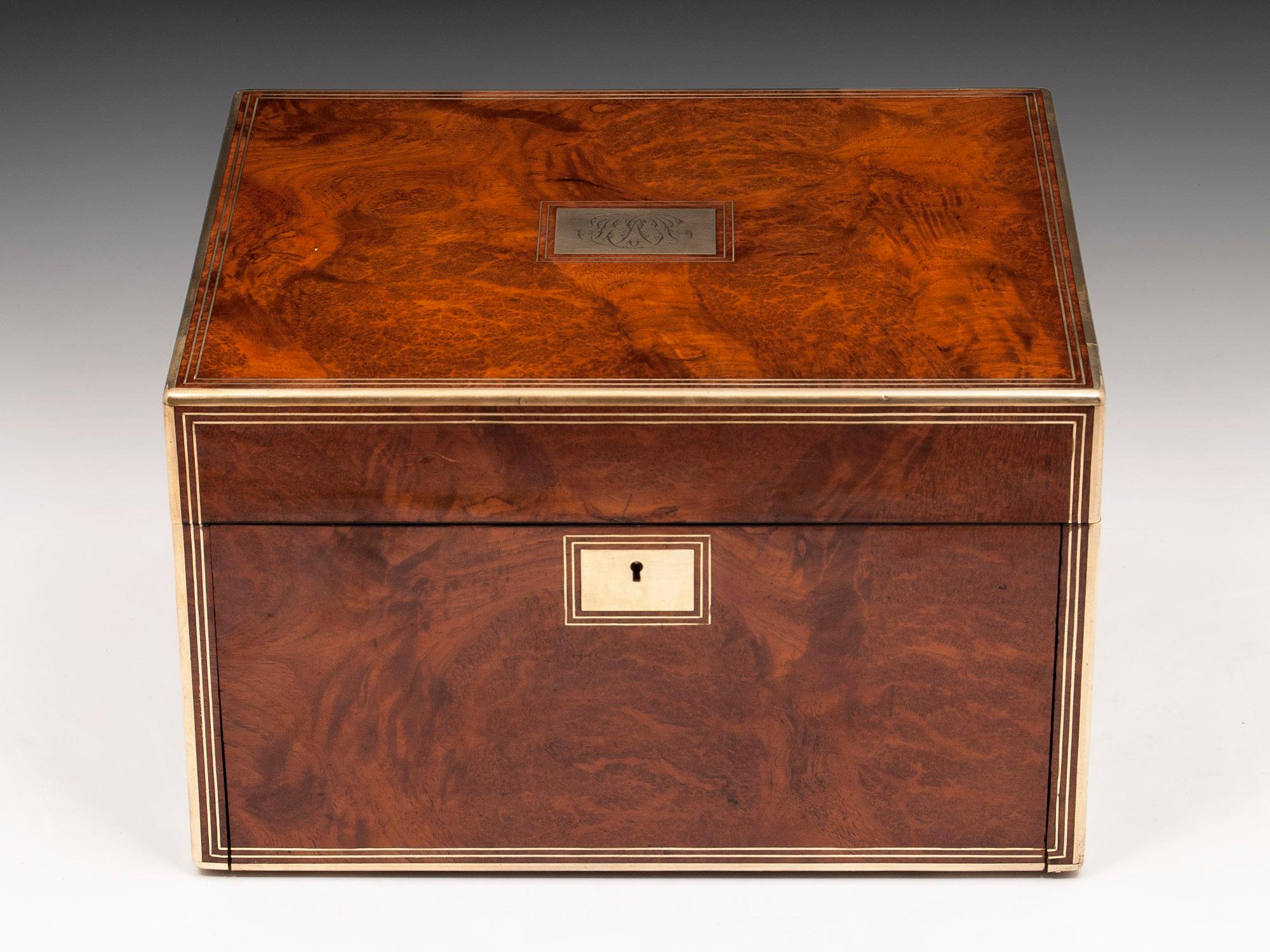 This magnificent silver gilt vanity box is veneered in stunning Amboyna.

Quadrant brass edging is on the box, along with escutcheons, stringing, and a makers label 