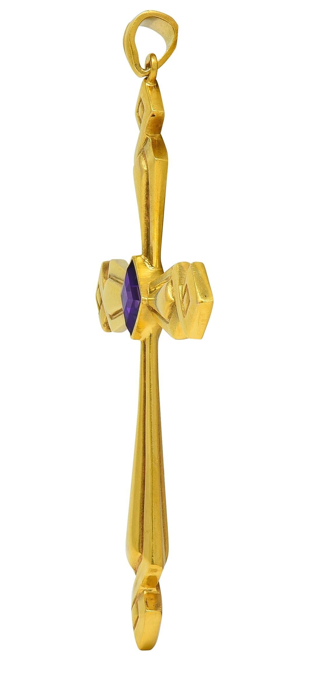 Designed as a cross shaped form suspending from a tapered bale
Yellow gold with a grooved geometric twist motif throughout
Centering a bezel set square step-cut amethyst
Measuring 5.2 x 5.2 mm - transparent medium purple
Stamped for 14 karat