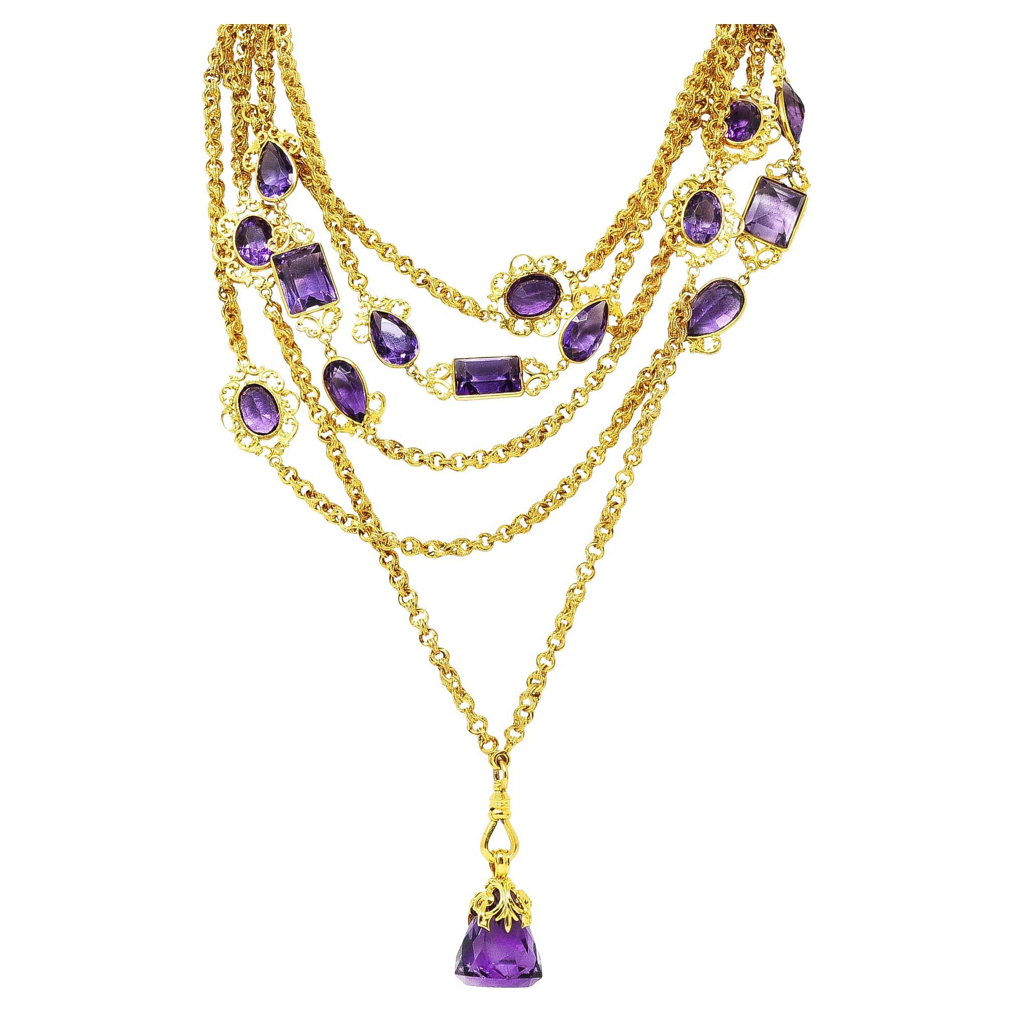 Comprised of stylized grooved cable links with milgrain edges featuring stations of bezel set amethyst. Oval, pear, and rectangular cuts ranging in size - transparent deeply saturated medium purple in color. Accented by scrolling foliate frame