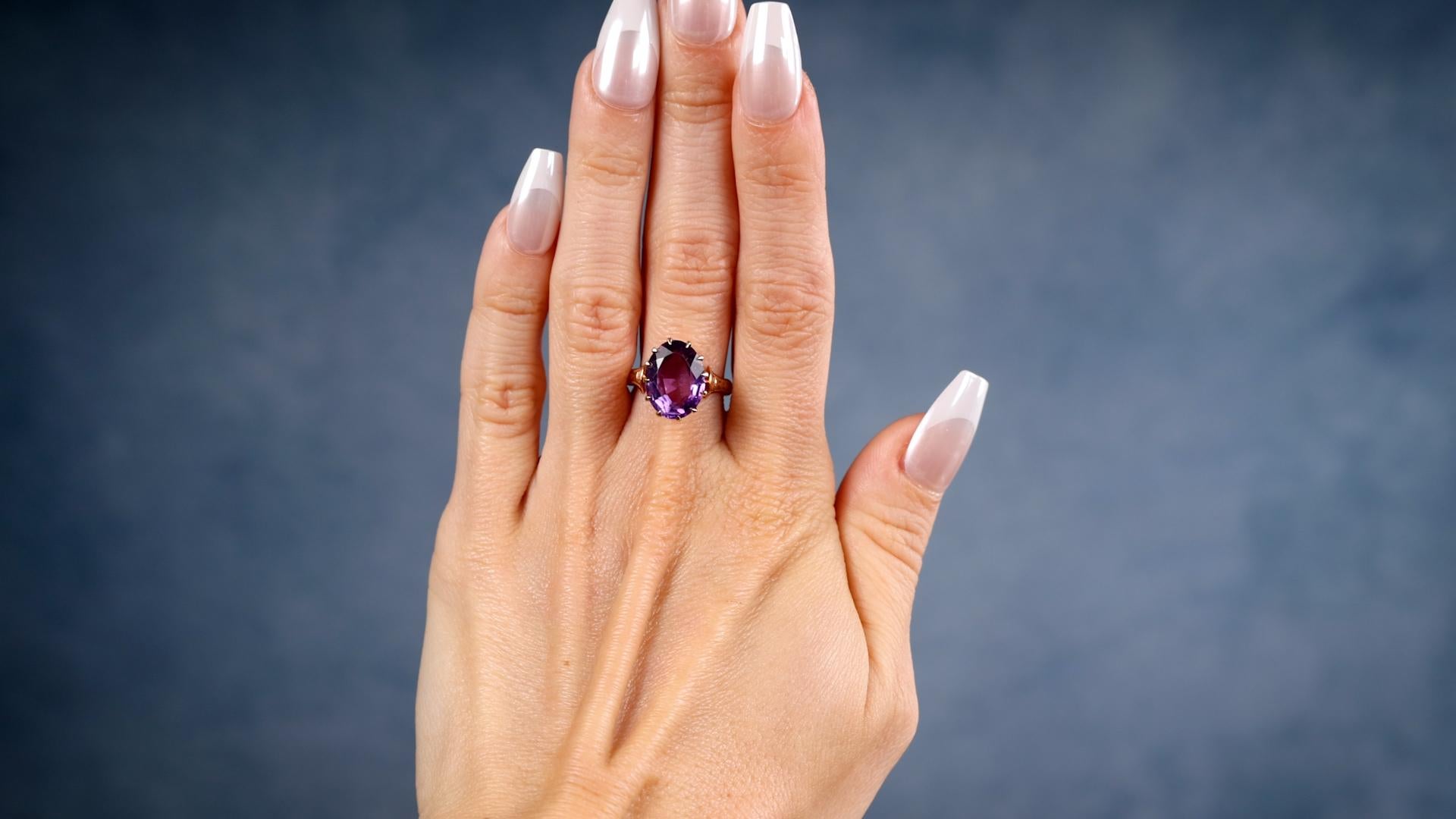 One Victorian Amethyst 14k Rose Gold Solitaire Ring. Featuring one oval mixed cut amethyst weighing approximately 4.10 carats. Crafted in 14 karat rose gold. The engraving inside the band reads “M.E.D., March 17, 1870.” Circa 1870. The ring is a