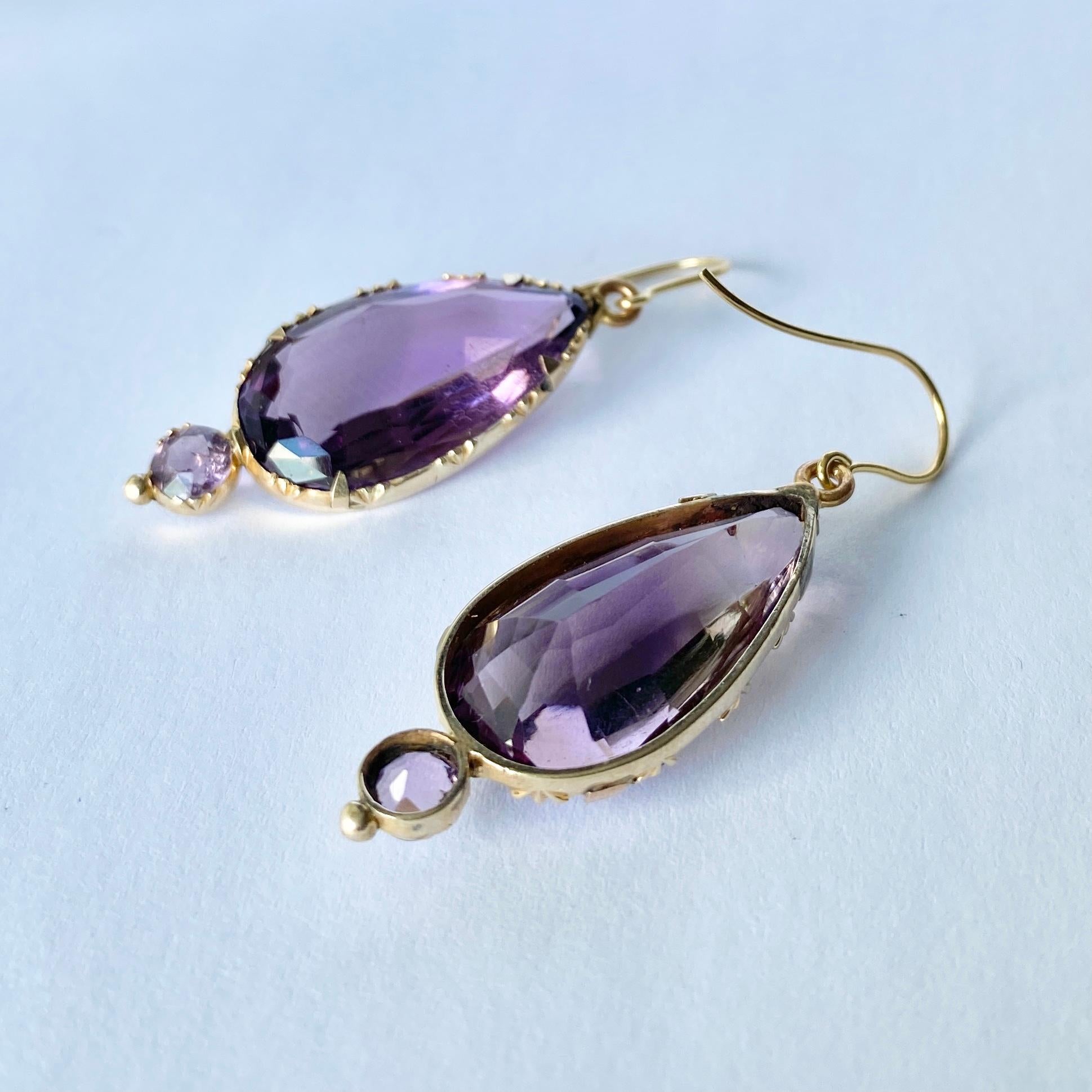 Striking victorian Amethyst drop earrings with charming detail around the setting. These earrings are modelled in 9ct gold. 

Total drop from ear: 47mm

Weight: 9g