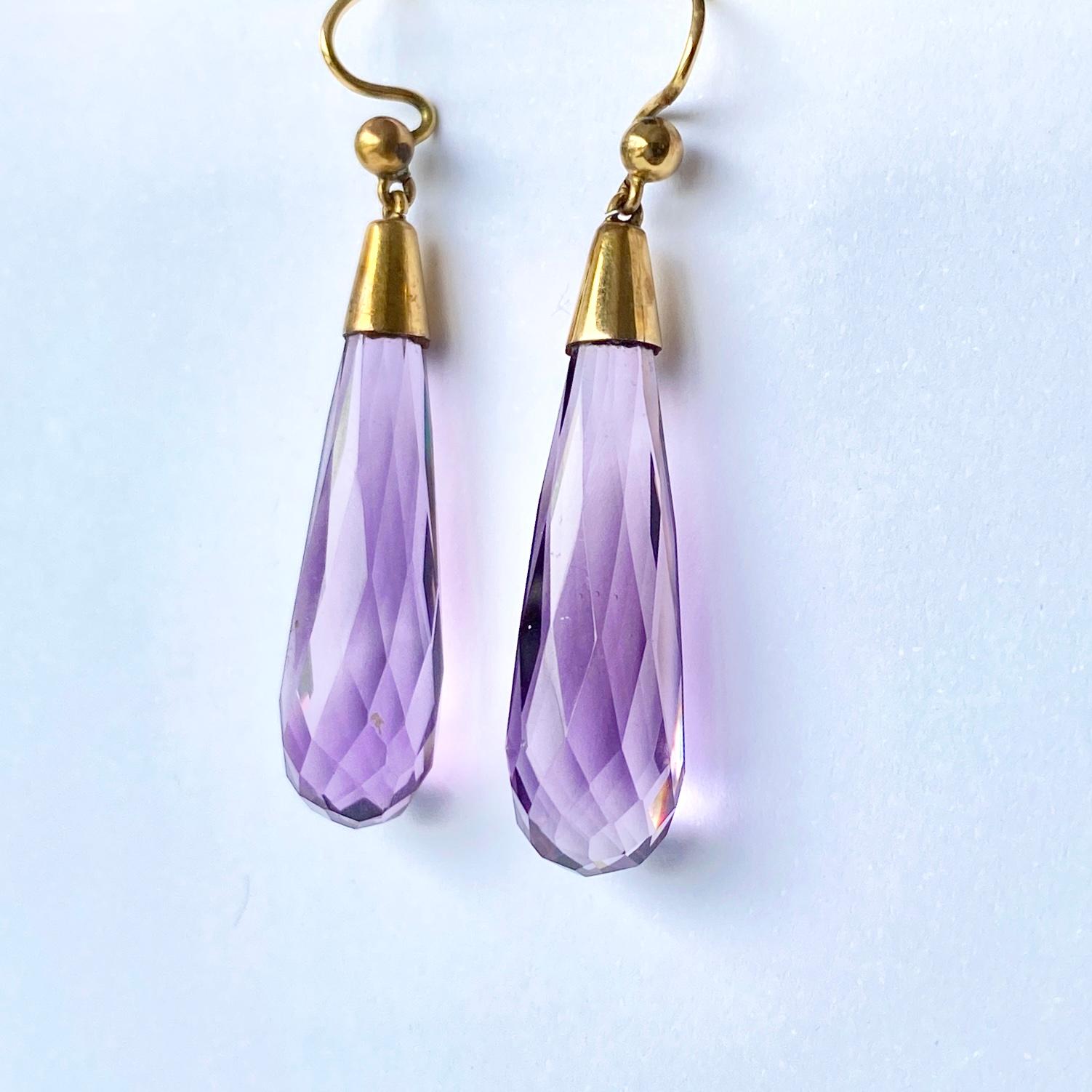 Striking Amethyst drop earrings cut beautifully to reflect the light. These earrings are modelled in 9ct gold. 

Total drop from ear: 45mm

Weight: 6.1g