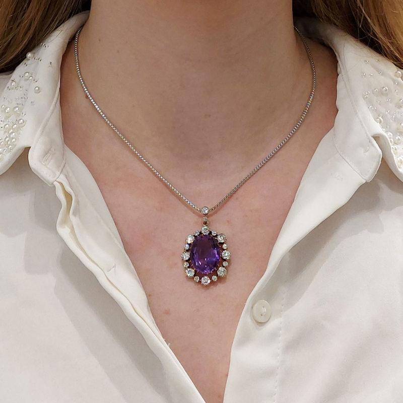 A spectacular Victorian amethyst and diamond cluster pendant set in silver on gold, circa 1901.

The pendant is centrally set with a gorgeous oval cut amethyst of a deep purple colour. The stone is estimated to weigh a staggering 12.50 carats and is