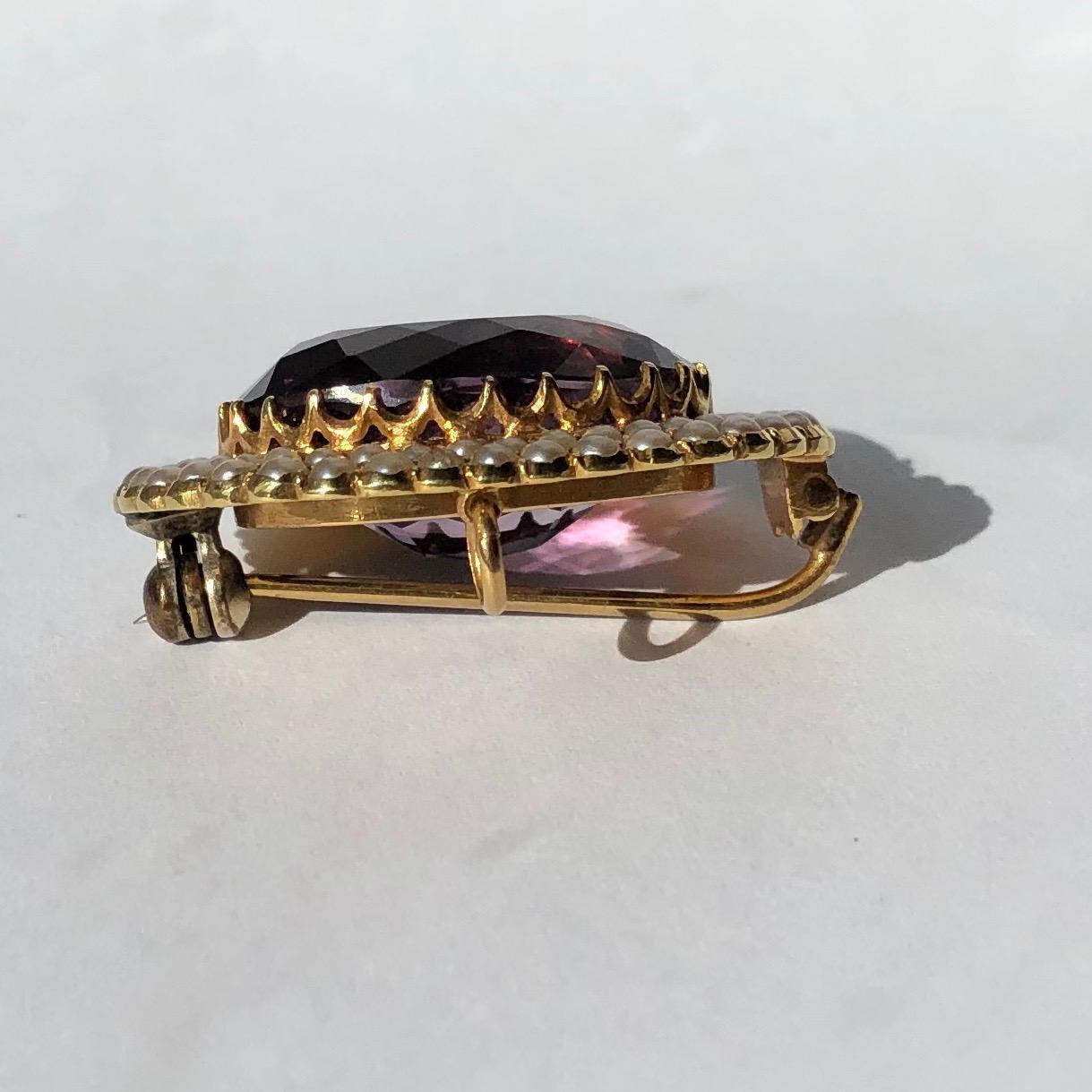 This stunning brooch holds a large amethyst stone which is a gorgeous pale purple colour and is complimented perfectly by the double row of pearls surrounding it. On the back there is the brooch pin and also a hoop so this could be worn as a brooch