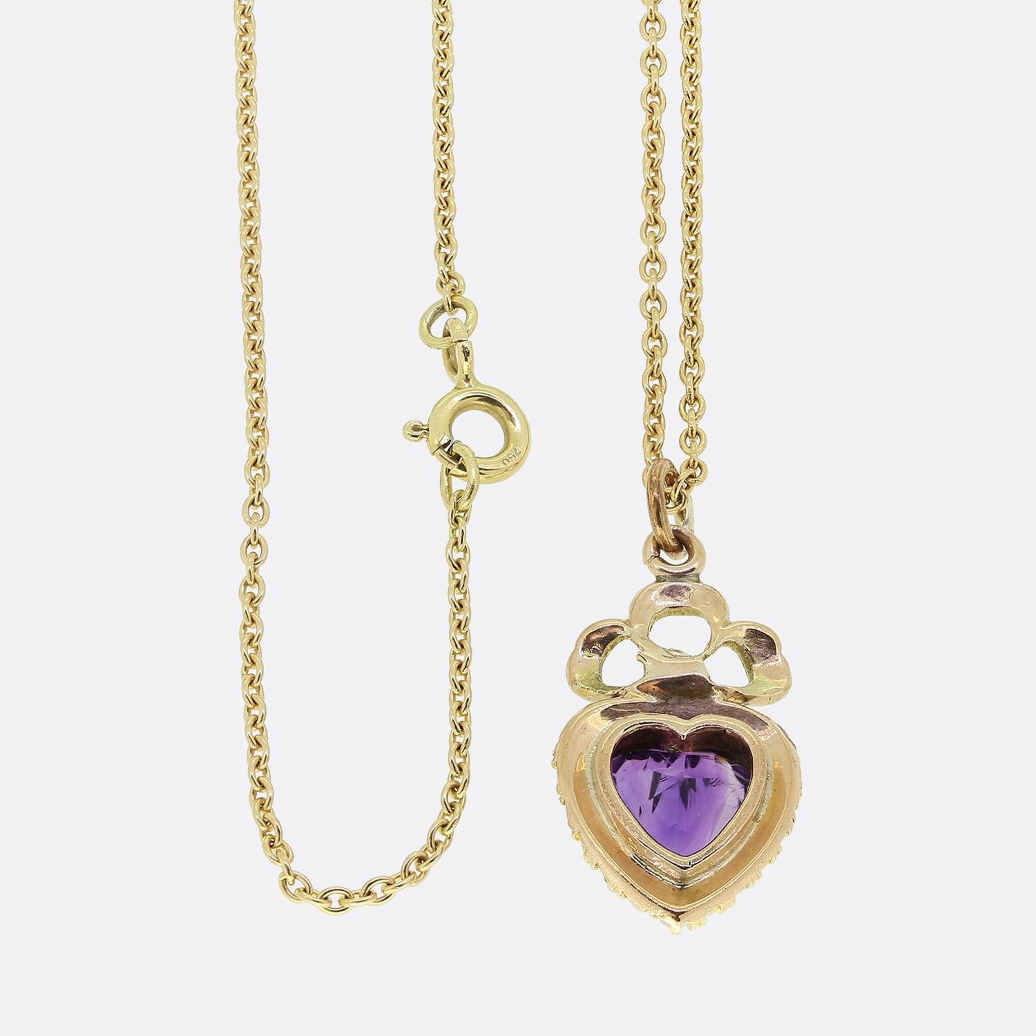 Here we have a stunning amethyst and pearl set pendant necklace. This antique pendant showcases an expertly crafted heart shaped amethyst possessing a rich purple colour tone. This centralised gemstone sits slightly risen and is framed by a single