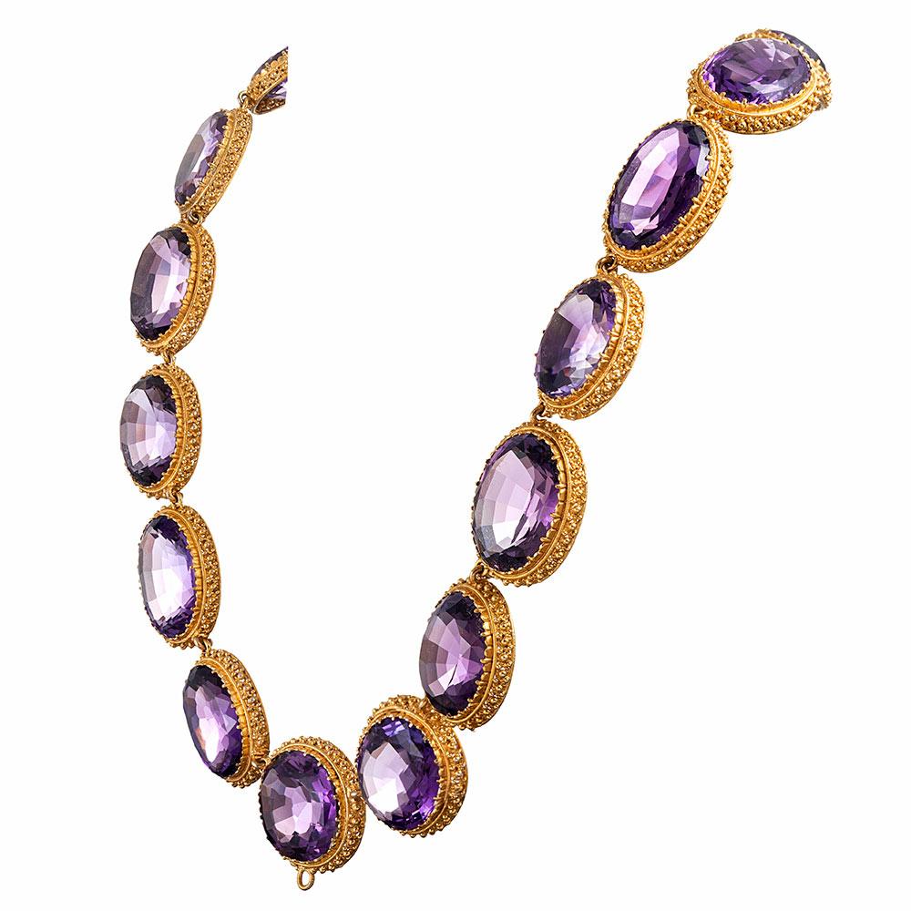 Substantial and glamourous, this Victorian Collar is set with large faceted ovals of exceptionally color-saturated amethyst, each stone nestled in its own granulated golden bezel. The absence of diamonds, yet assertive size allow this piece to be