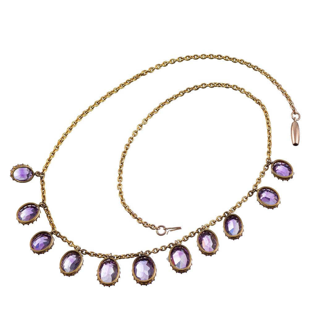 This classic Victorian necklace is appointed with eleven faceted oval amethyst gemstones and looks absolutely stunning when draped on the body. The gently graduated pendants adorn the neck in glorious Victorian style. This piece moves gently with