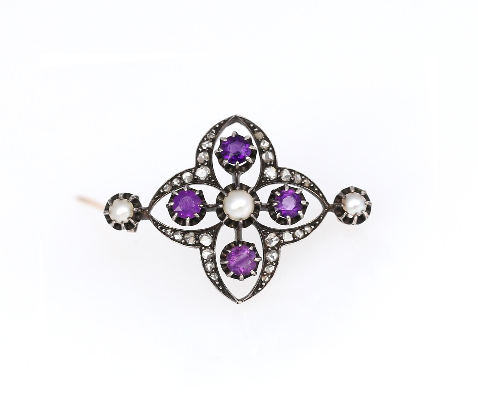 Late Victorian Brooch with four bright Amethysts, three fine Pearls and Rose-cut Diamonds. Set in Silver and Gold. Shaped in natural organic form resembling a flower, yet made in 1900 it has fine geometrical proportions.

Once it was common to