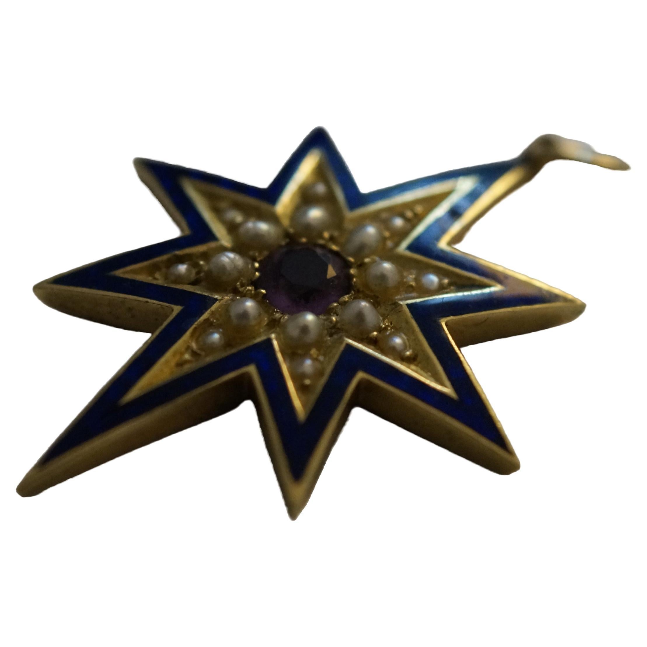 A sensational and impressive Victorian star pendant crafted in 9 carat gold, with vivid royal blue enamel work, seed pearls and a brilliant central amethyst stone. This beautiful antique medallion is circa 1845. 

14 seed pearls of excellent quality