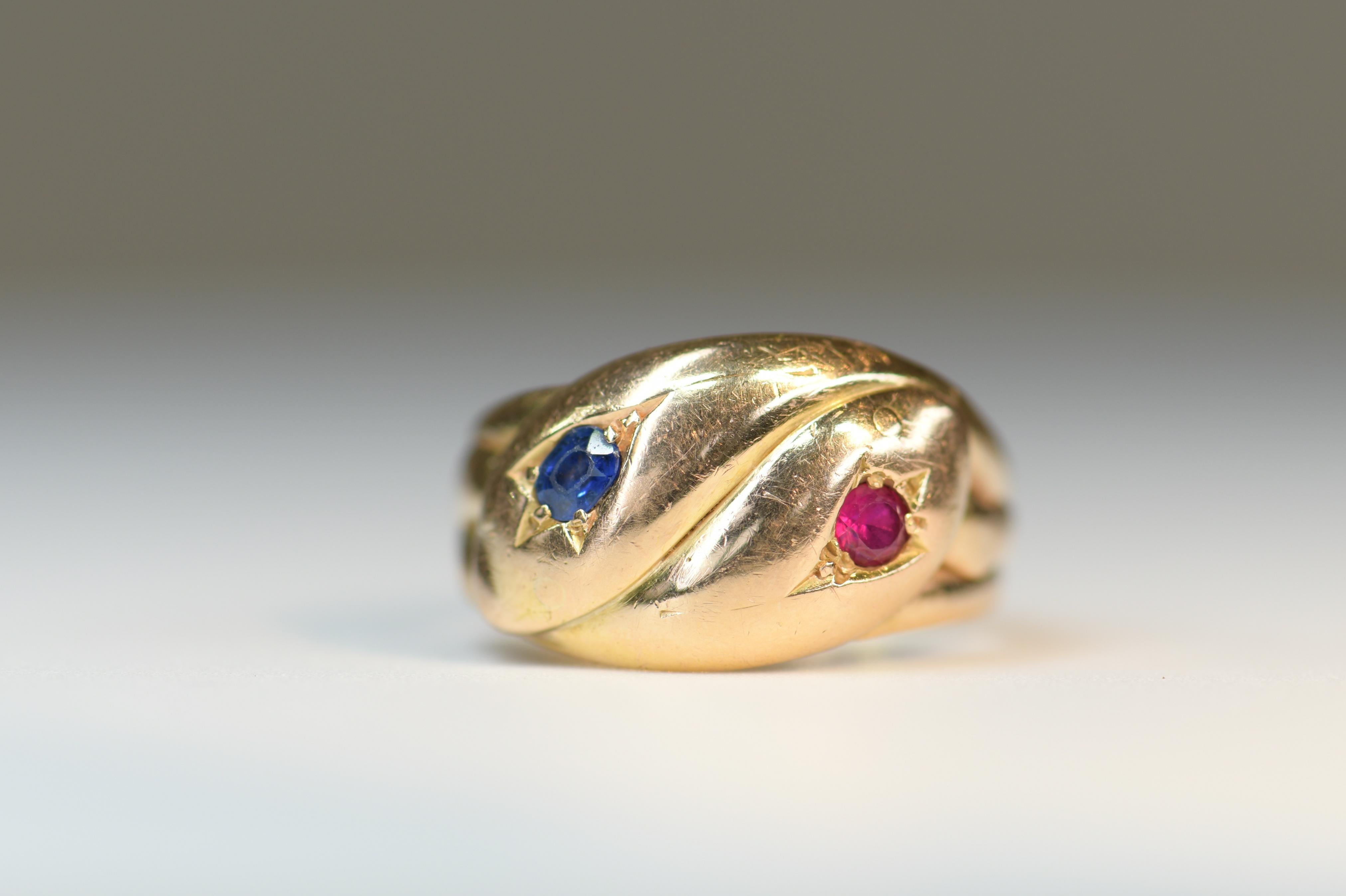 Stunning antique victorian double snake serpent ring. 2 yellow gold snakes entwined together with ruby and sapphire gem set heads.

Snakes are a symbol of everlasting eternal love, and became quite popular in the 1800's when Prince Albert presented