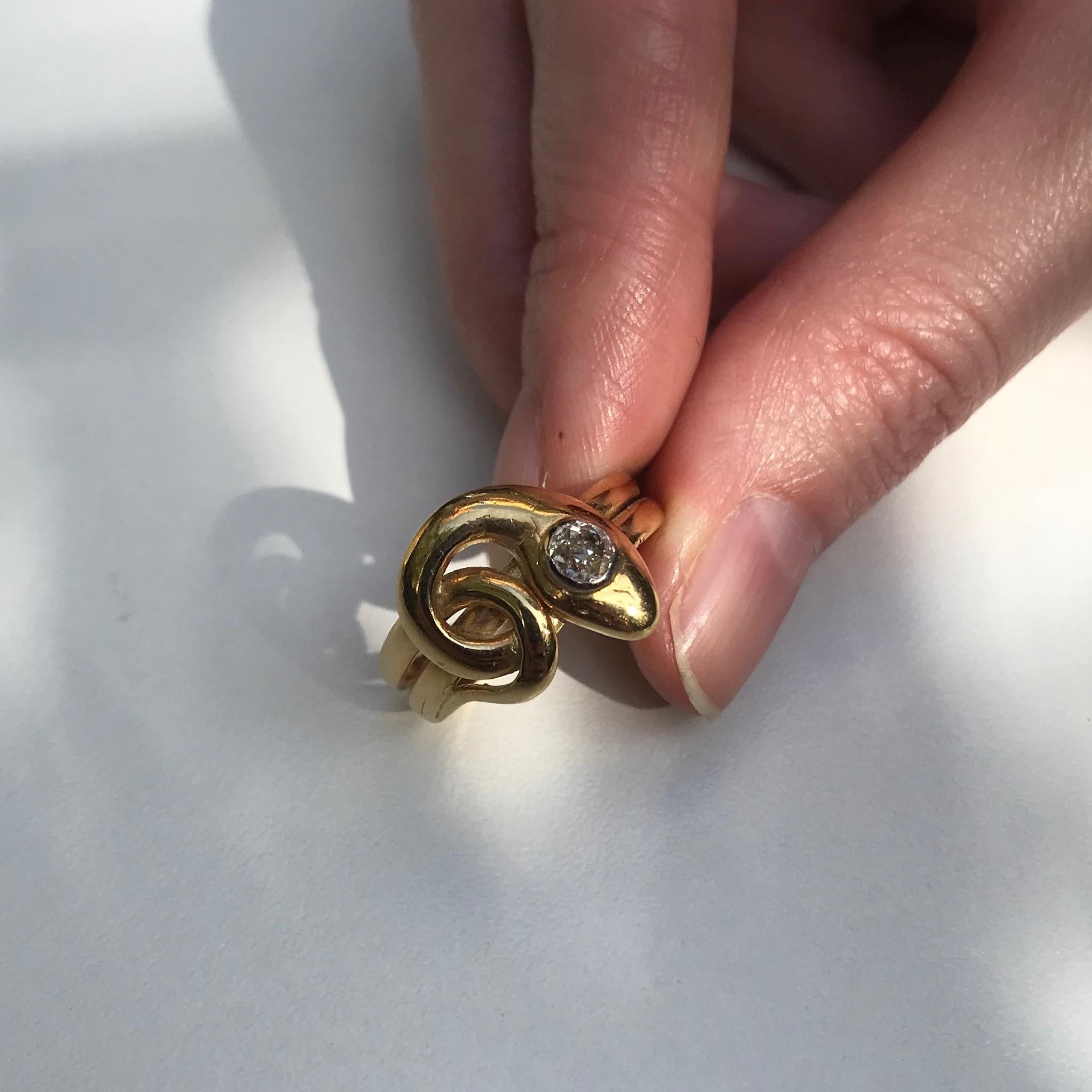 A 19th century Victorian coiled snake ring in 18 karat yellow gold set with 1 old European cut diamond .25 carat (color and clarity grade: M, i). Ring size 8¼, can be sized.