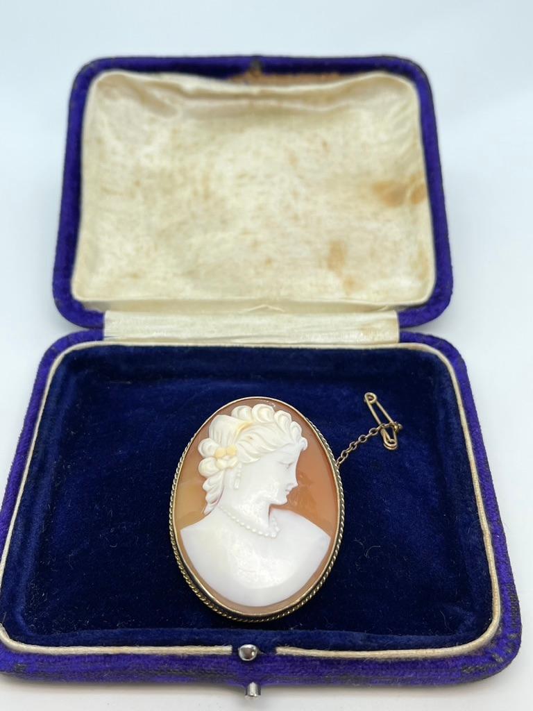 We call this Unique Piece, 'The Lady Wearing Pearls’.

This is a quality antique Cameo brooch that is nicely carved to depict an elegant lady wearing a pearl necklace and earrings. Her curls are upswept and held with a little flower.  Cira 1890 she