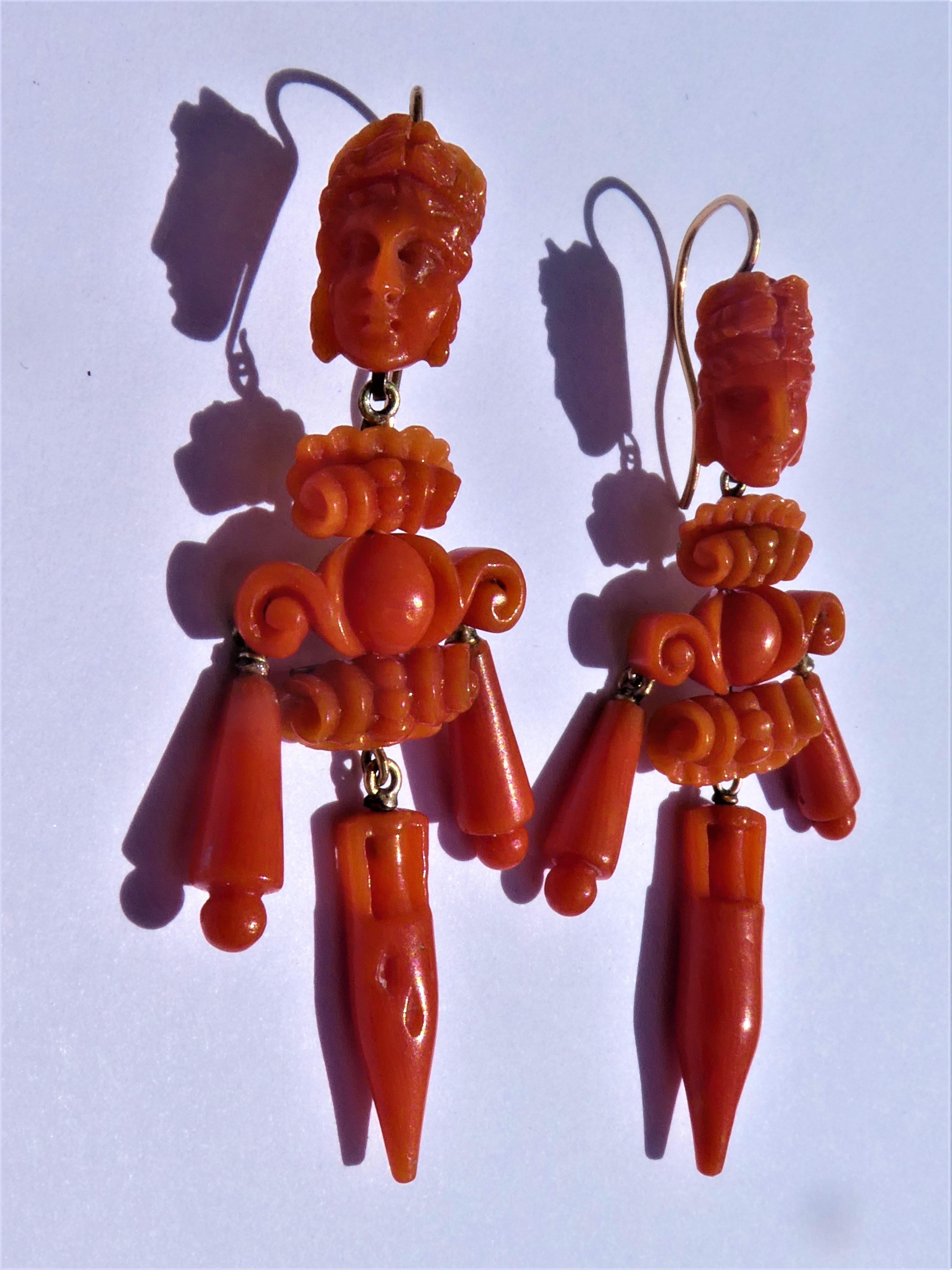 The vibrant deep red coral of these hanging earrings is from Sardinia in the Mediterranean sea. They were beautifully hand carved around 1850 in Victorian times in an ancient Neapolitan tradition in Neoclassical style. One can see a lady´s head with