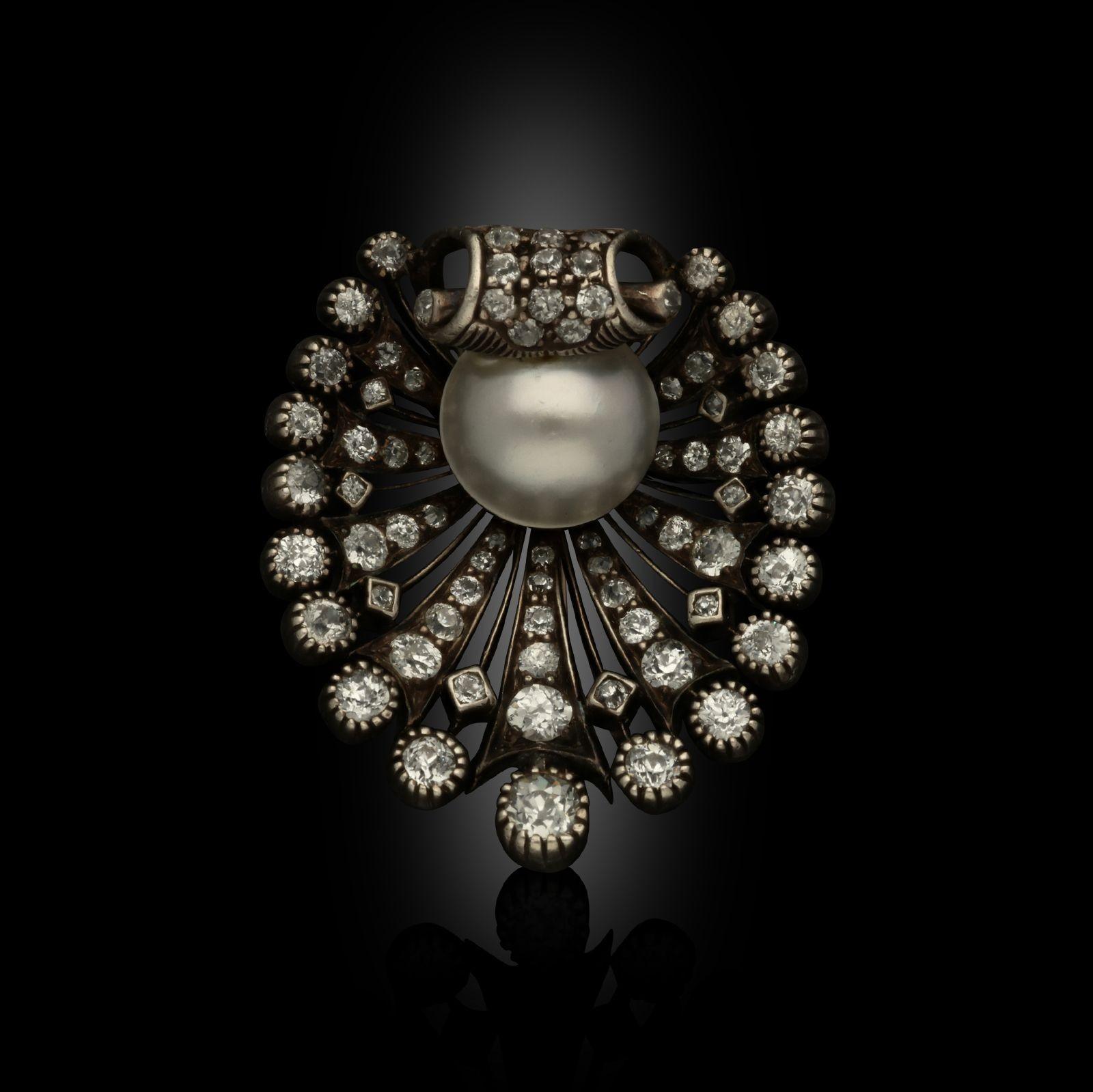 A beautiful Victorian diamond and pearl shell brooch c.1880s, the three-dimensional scallop shell of oval outline set throughout with old European brilliant cut diamonds in silver backed with gold, the rows of diamonds all radiating outwards from