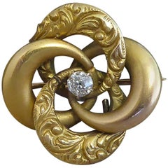 Victorian Antique Diamond Brooch, Gold Engraved Knot, circa 1890s, 15 Carat Gold