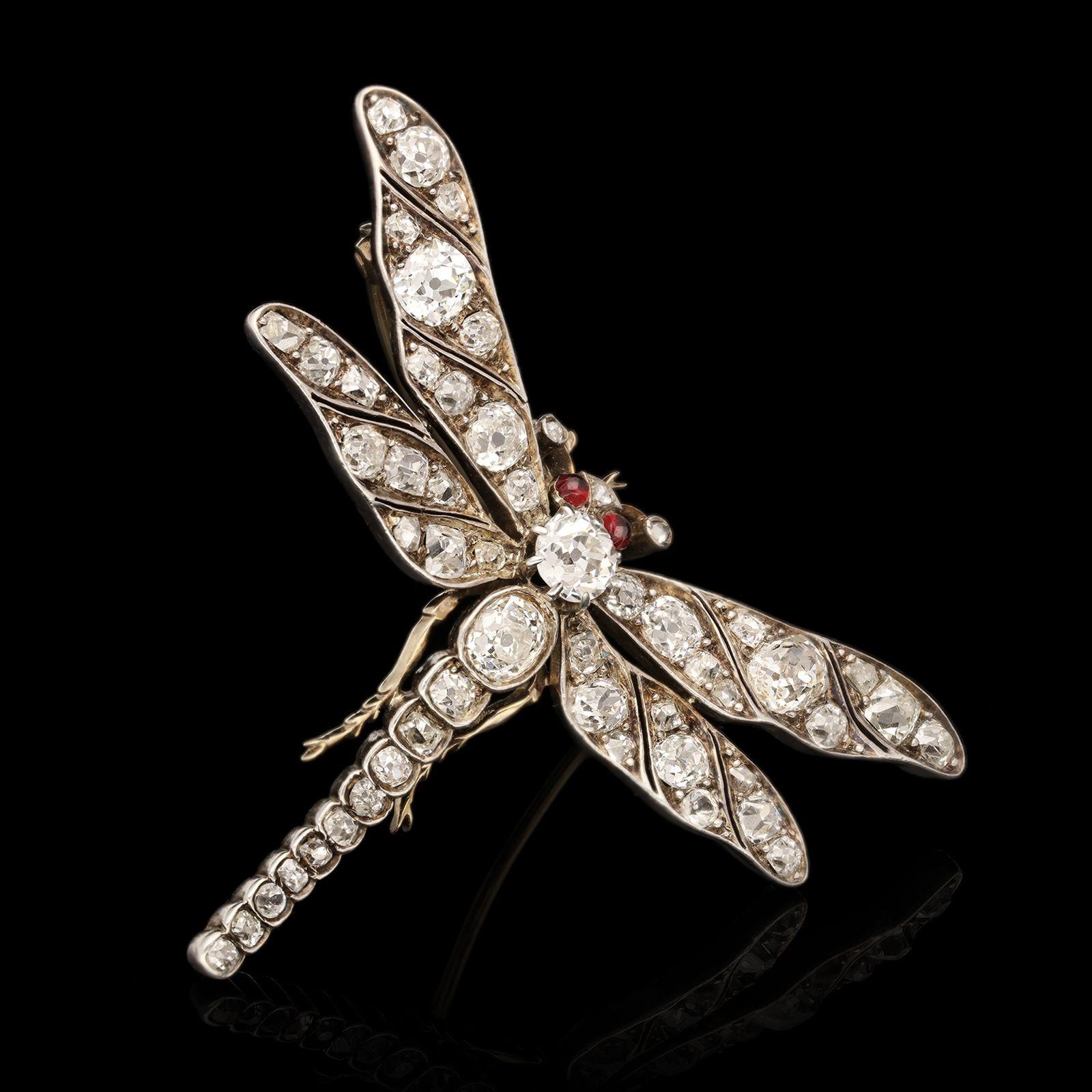 A beautiful Victorian diamond dragonfly brooch, c.1870s, the openwork design realistically modelled in silver and gold depicting a dragonfly in flight with wings outspread, the tapering body and wings set throughout with old cut diamonds and the