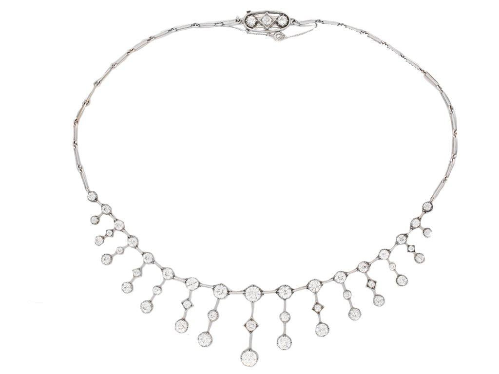 Antique diamond necklace. Set with one round old cut diamond in an open back cutdown setting with a weight of 1.20 carats, further set with one round old cut diamond in similar settings with a weight of 1.10 carats, additionally set with forty six