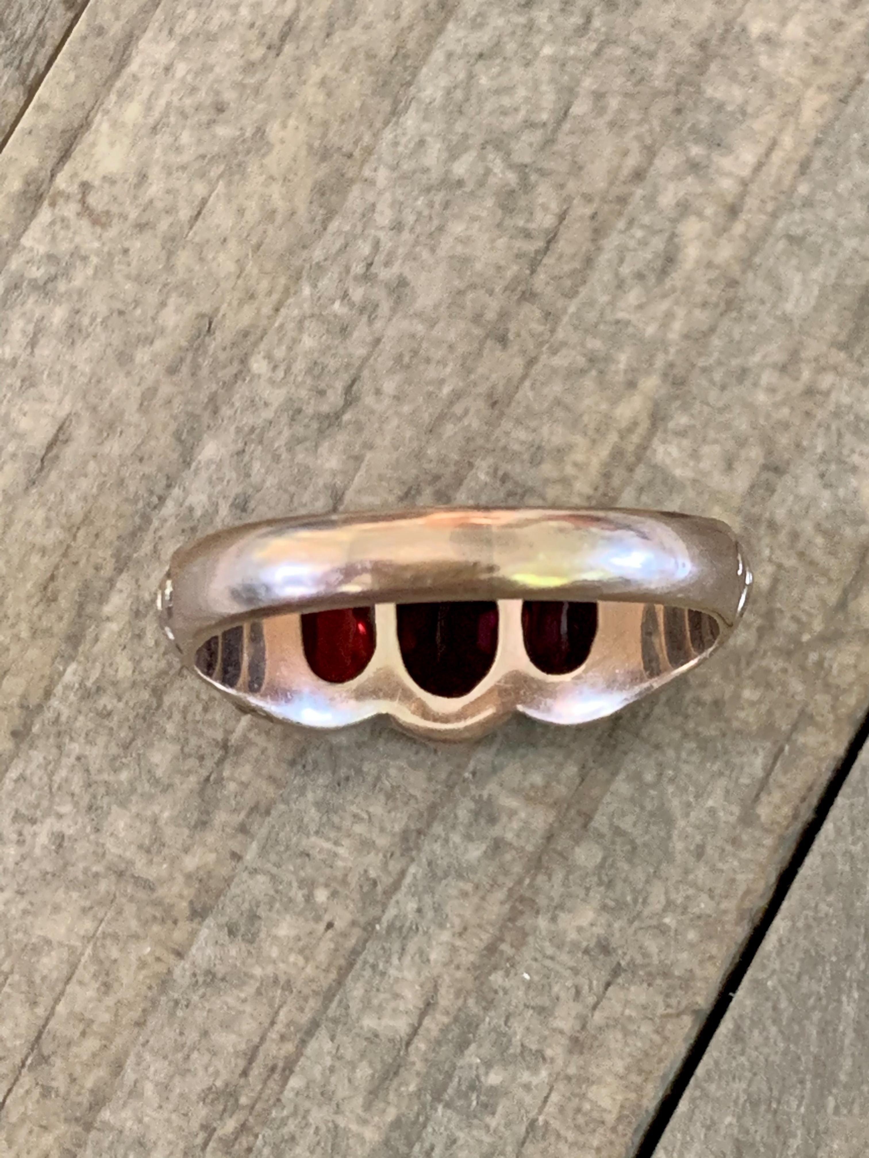 This Victorian men's ring features three faceted Garnets which are prong set in an engraved 14k yellow Gold setting.

The face of the ring measures: 1