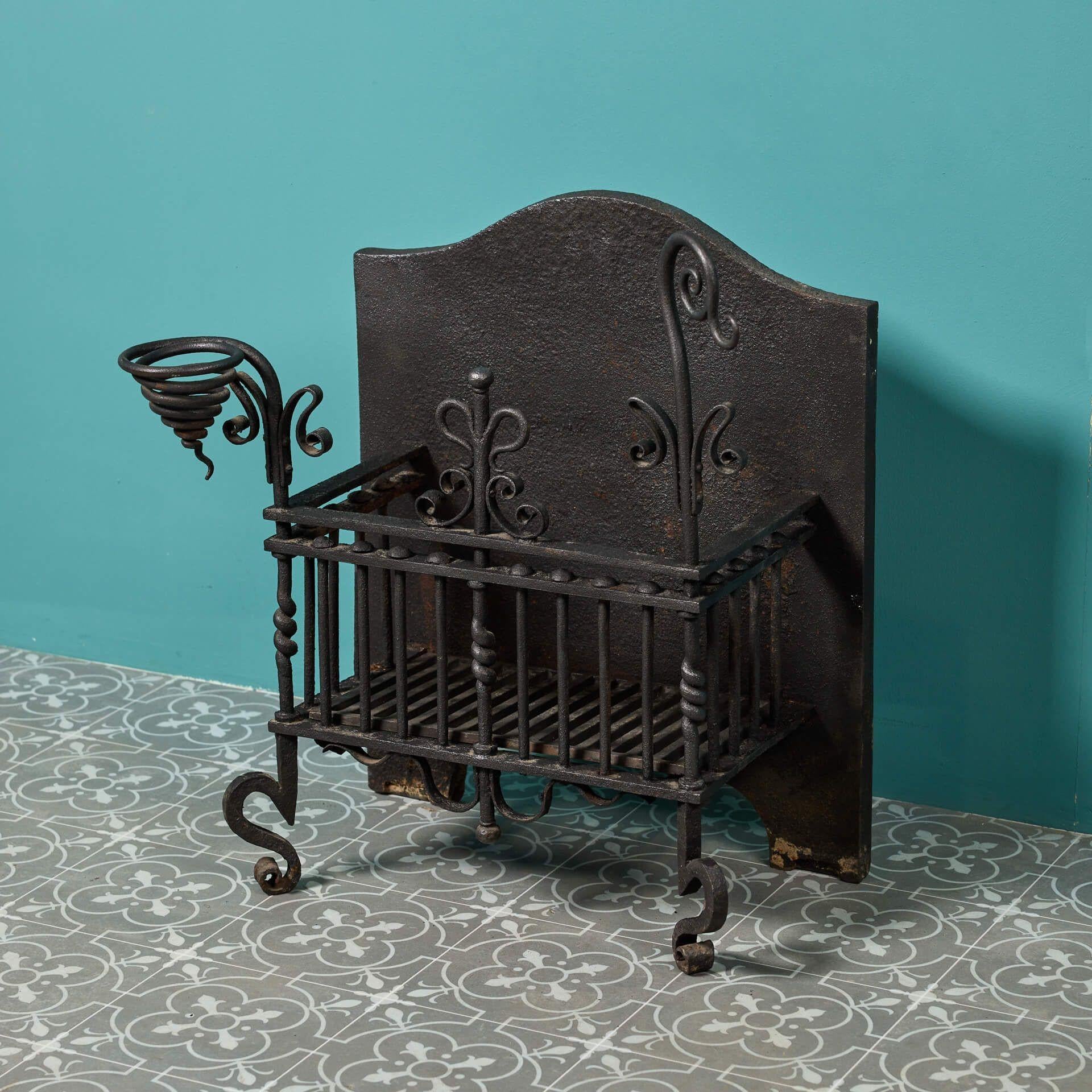 Dating from the late 19th century, this Victorian antique fire brazier is decoratively made using a range of techniques. While the back is cast in iron – as is typical of many antique fire baskets – the front is finely worked in wrought iron, heated