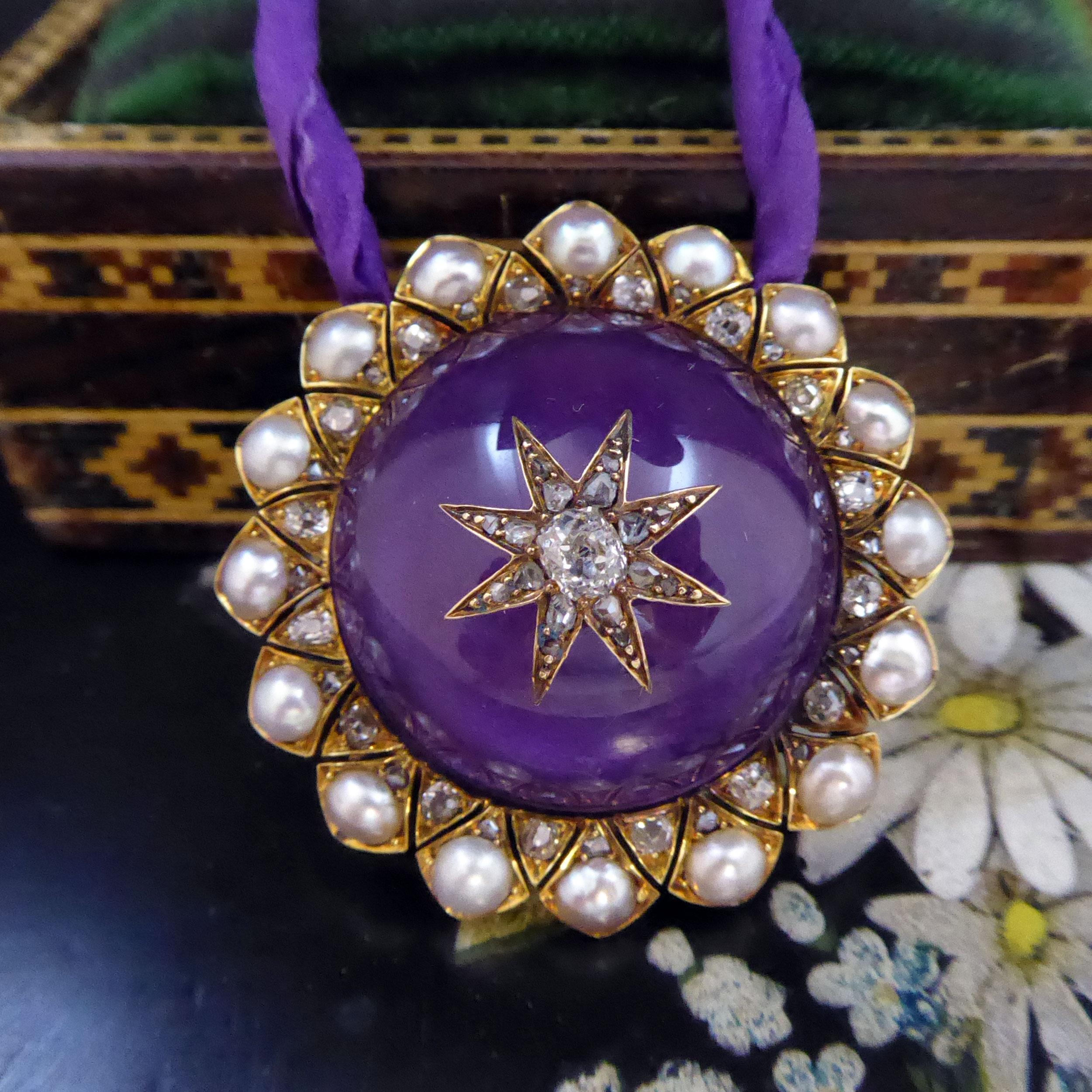A fabulous cabochon cut amethyst is the stand out feature of this Victorian pendant.  The amethyst measures approx. 1 inch in diameter and it is set to the centre with an oval, old cut diamond in a diamond-studded, star-shaped mount.   A pearl and