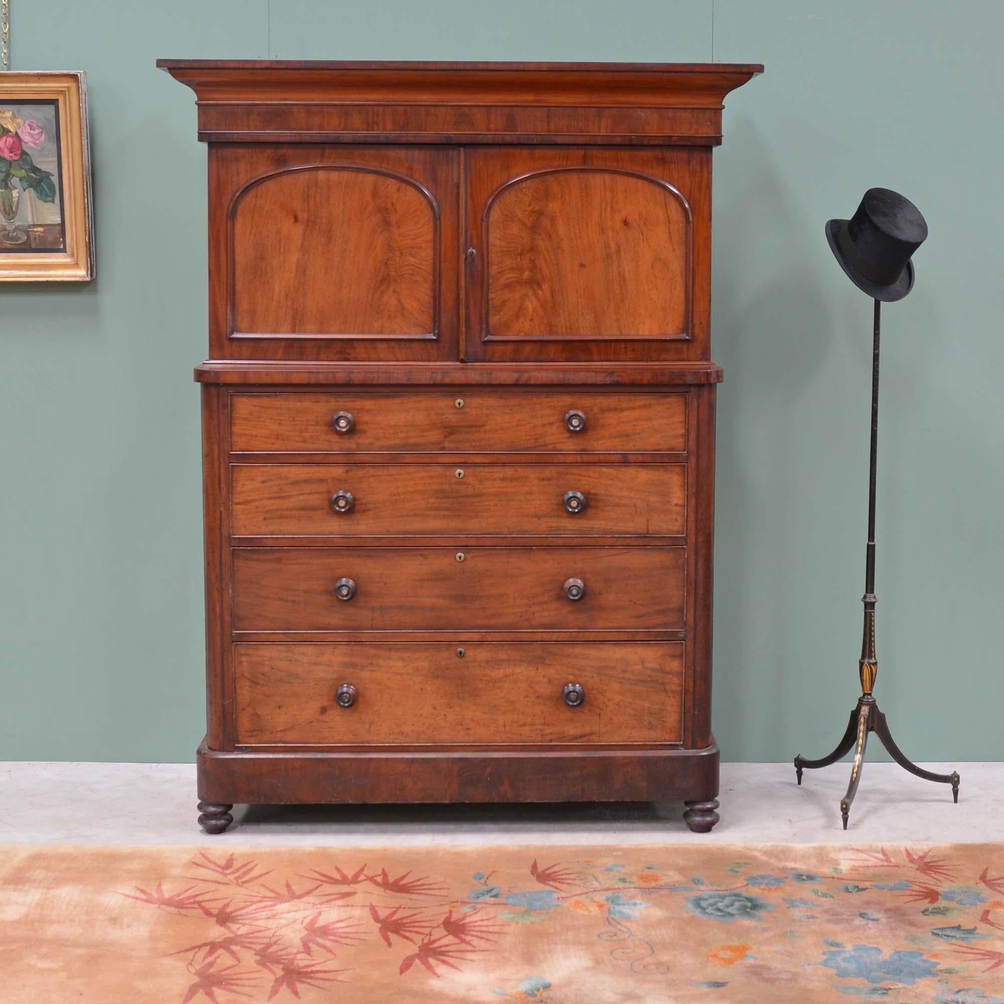 Victorian mahogany cupboard
Comprising a pair of panelled doors with domed panels, under and bold shaped ogee cornice.  The four long graduated drawers housed in a carcass with rounded corners, stands on a plinth base and bun feet.  Unusually this