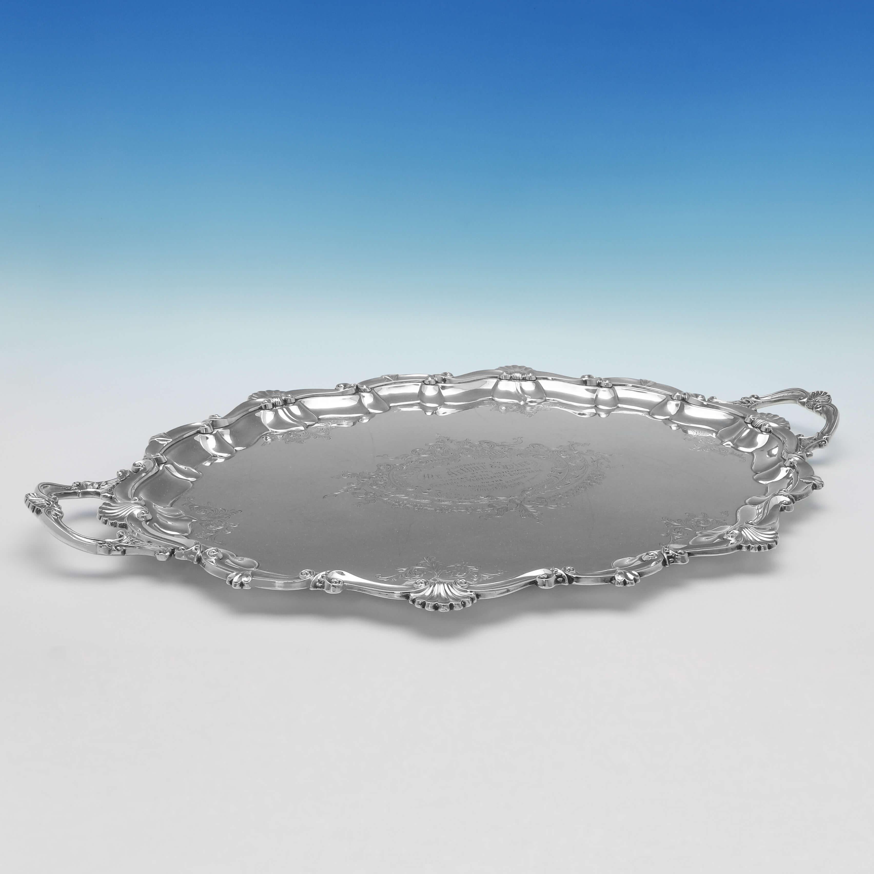 Made circa 1900, this striking, Victorian, Antique Silver Plate tray, features a shell and scroll border and handles, and an original presentation inscription to the centre. 
The tray measures 1.75