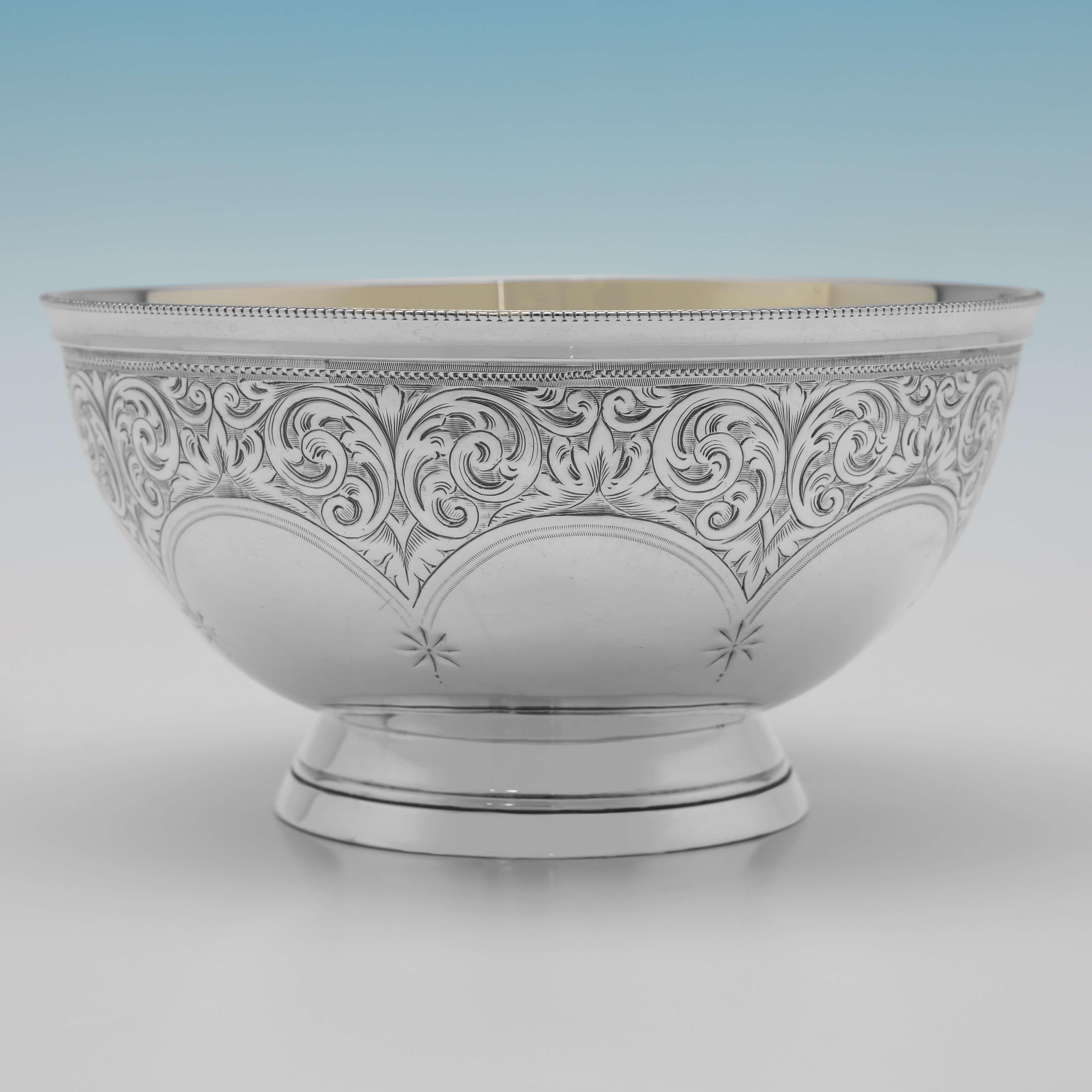 Hallmarked in London in 1891 by Edward Hutton, this very attractive, Victorian, Antique Sterling Silver Bowl, features a bead border, engraved decoration to the outside, and a gilt interior. 

The bowl measures 2.5