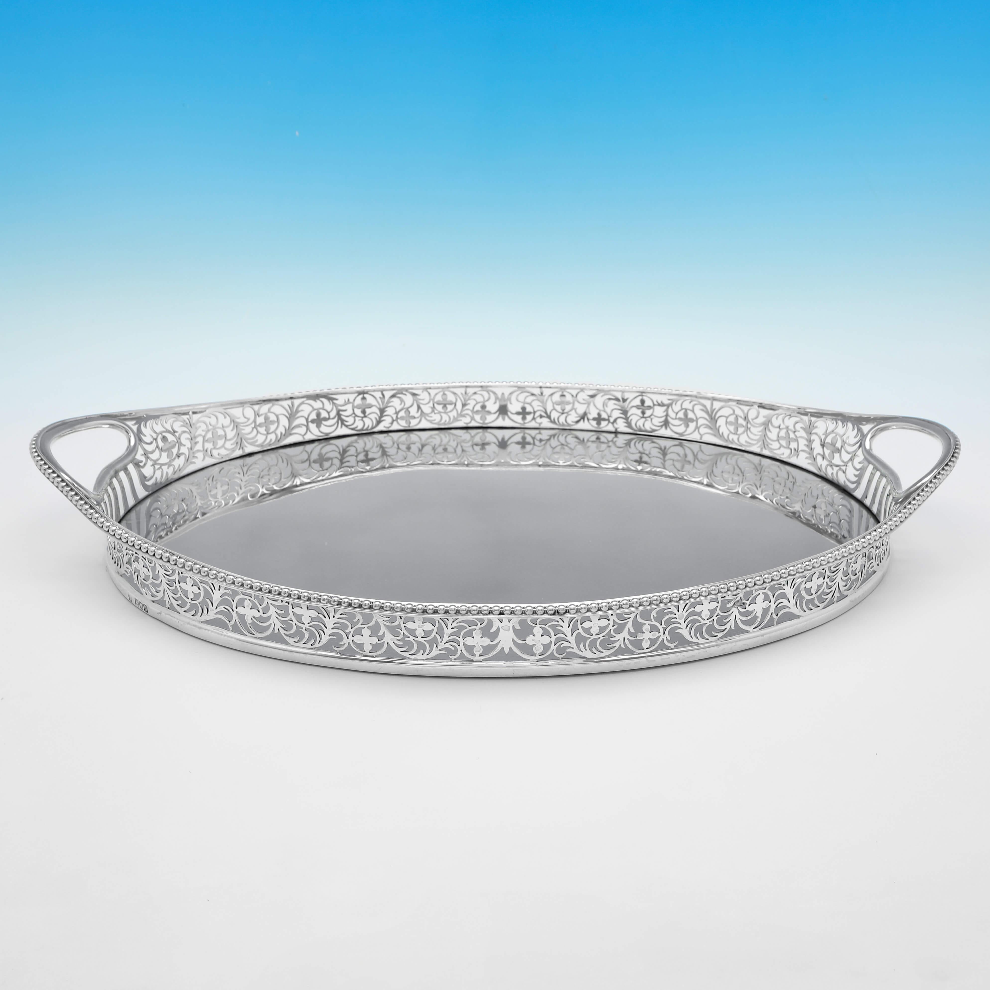 Hallmarked in London in 1899 by Charles Stuart Harris, this attractive, Victorian, Antique Sterling Silver Gallery Tray, is oval in shape, and has a wonderfully decorative pierced border. 

The tray measures 2.5