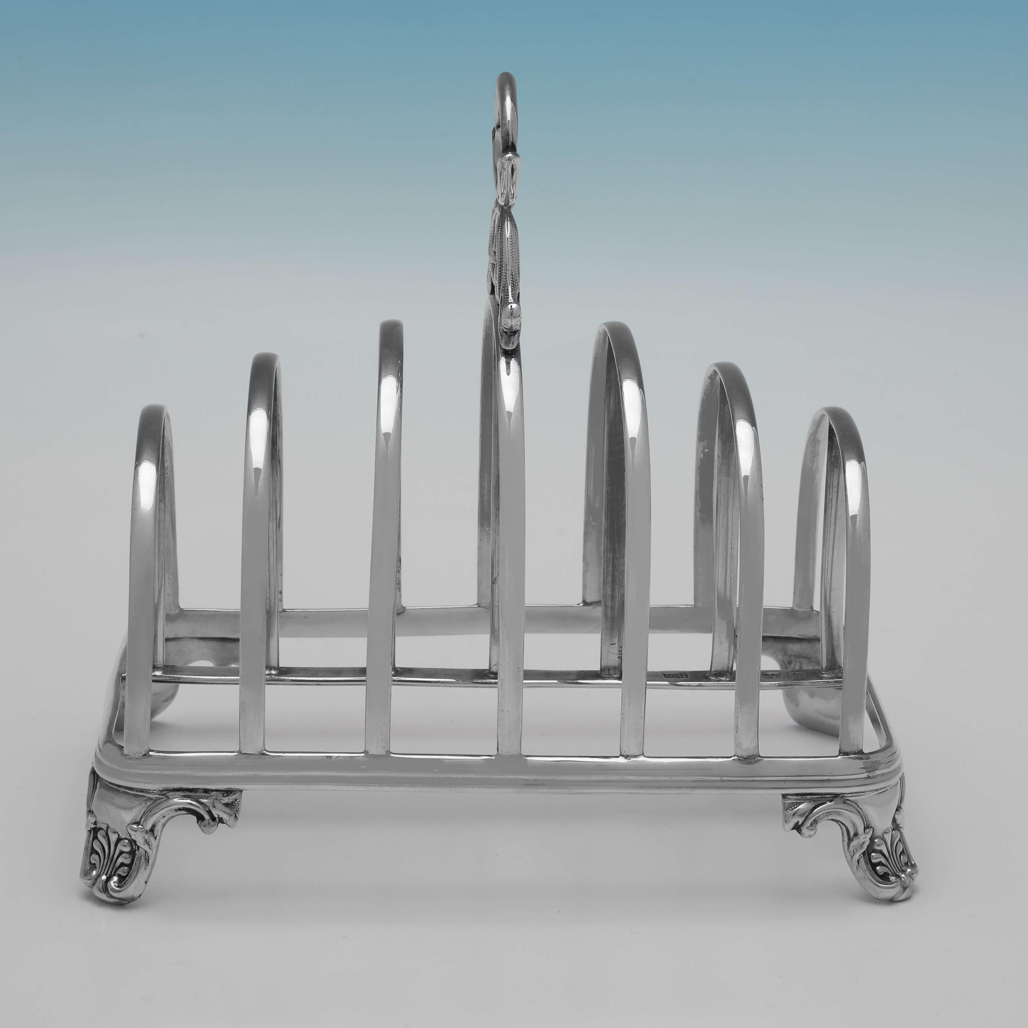 Hallmarked in sheffield in 1845 by Henry Wilkinson & Co., this handsome, Victorian, antique sterling silver toast rack, will hold 6 pieces of toast, and features shell and scroll feet, and acanthus detailing to the handle. 

The toast rack